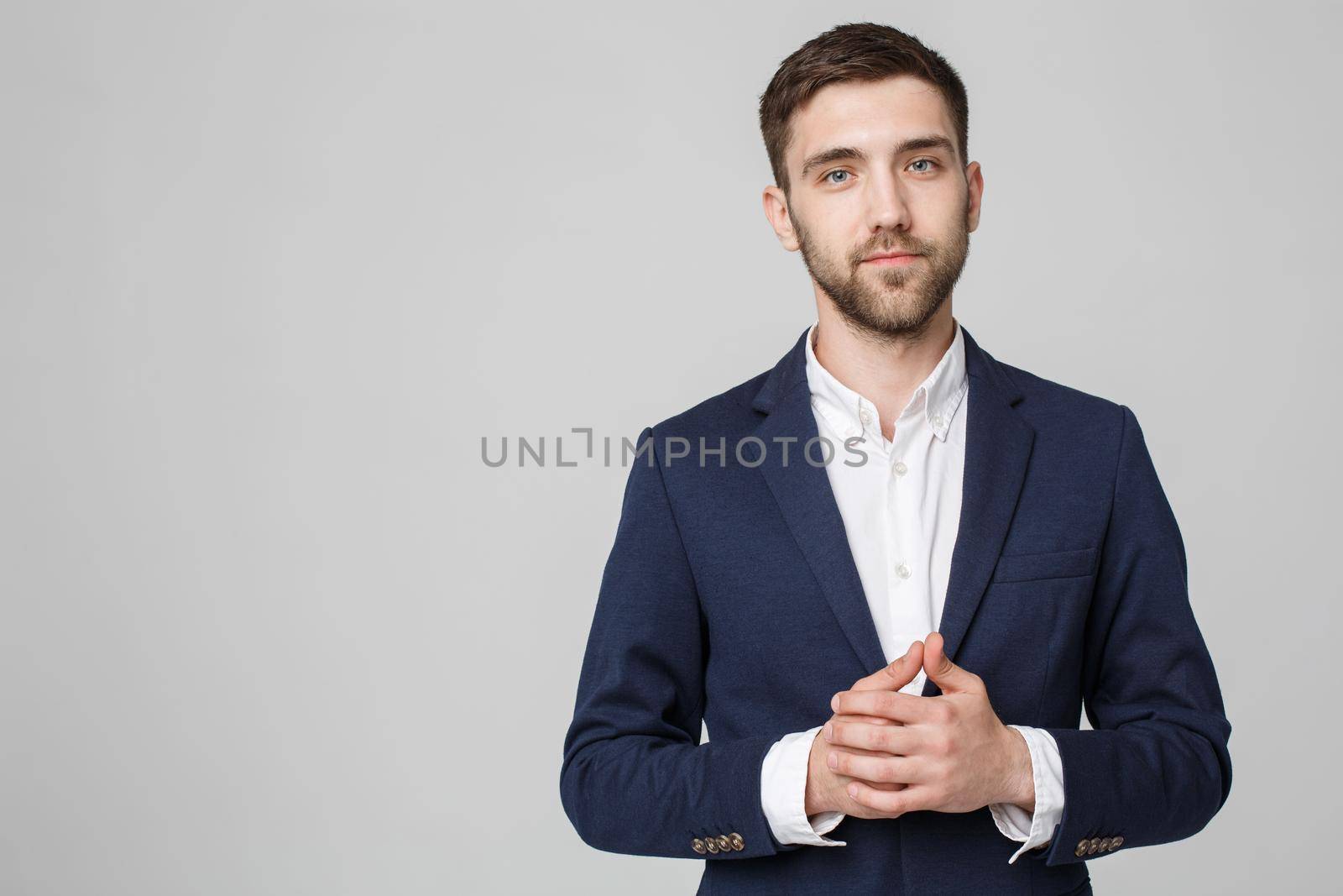 Business Concept - Portrait Handsome Business man holding hand with confident face. White Background. Copy Space. by Benzoix