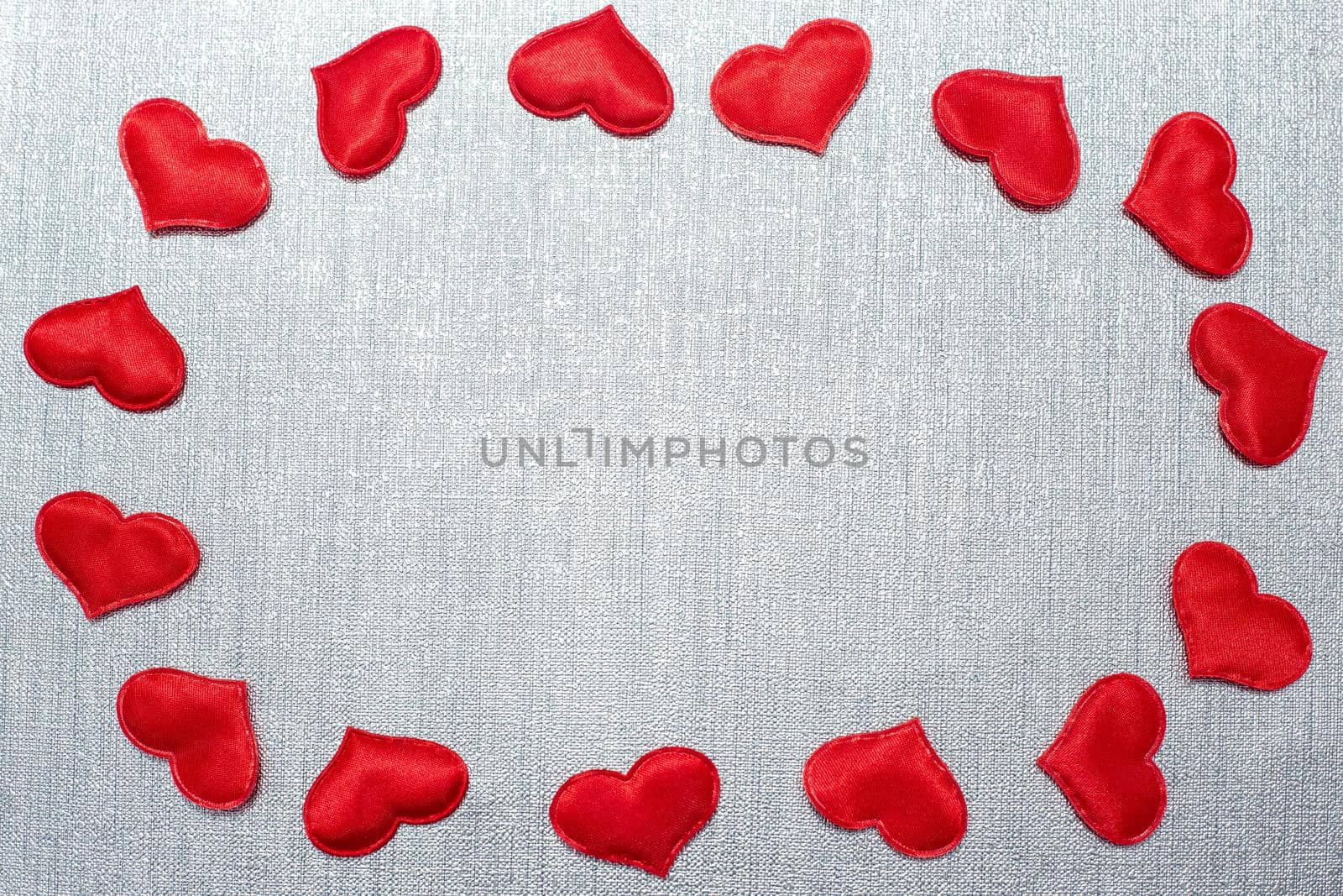 red hearts laid out in the shape of an oval on a silver background by levnat09