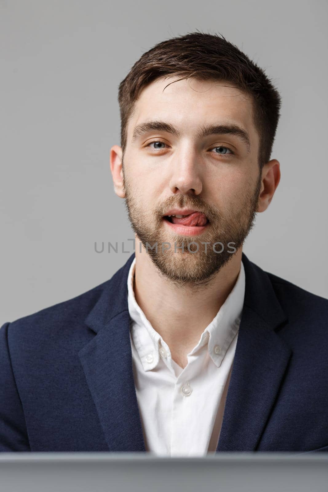 Business Concept - Portrait handsome happy handsome business man in suit smiling and siting in work office. White Background. by Benzoix