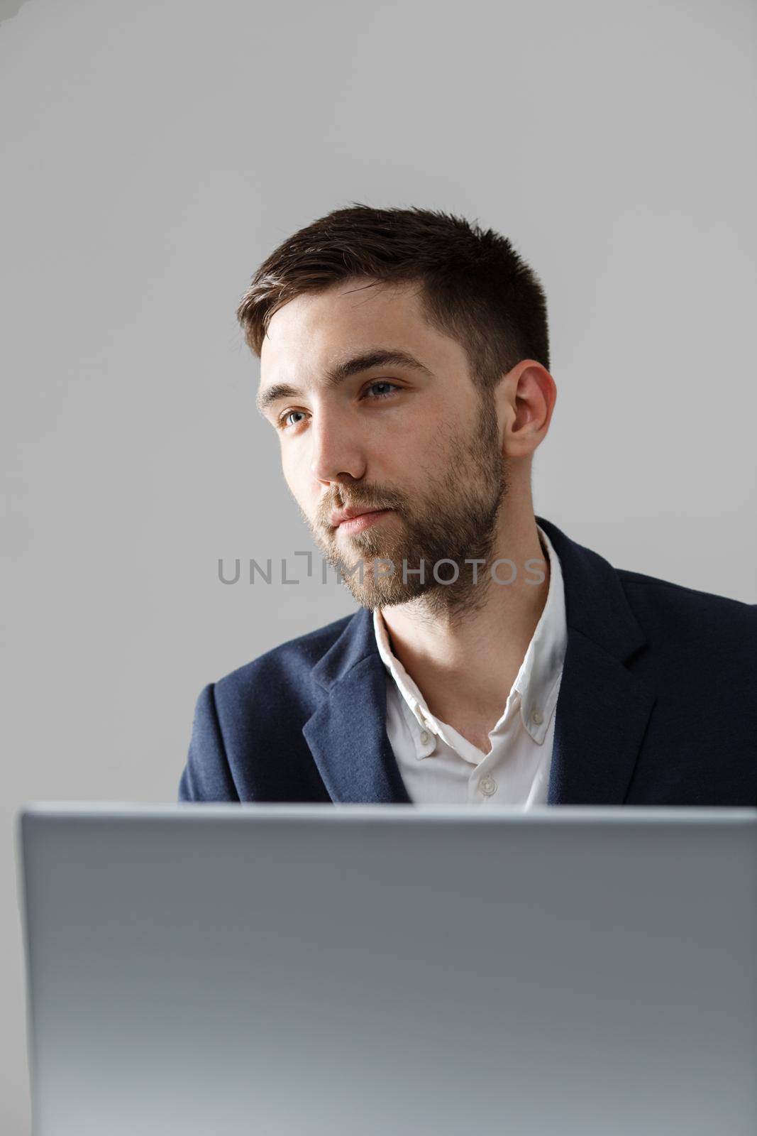 Business Concept - Portrait handsome stressful business man in suit shock looking in front of laptop at work office. White Background. by Benzoix