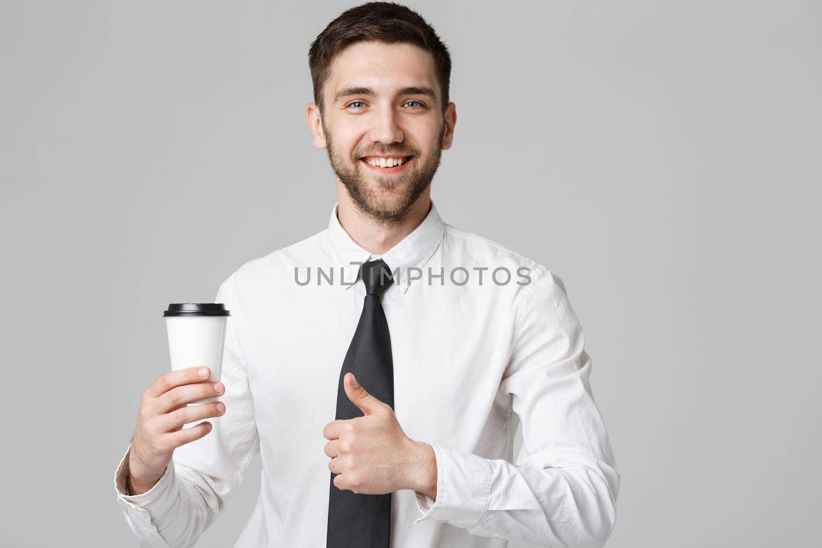 Portrait of a handsome businessman in formal suit with a cup of coffee. by Benzoix