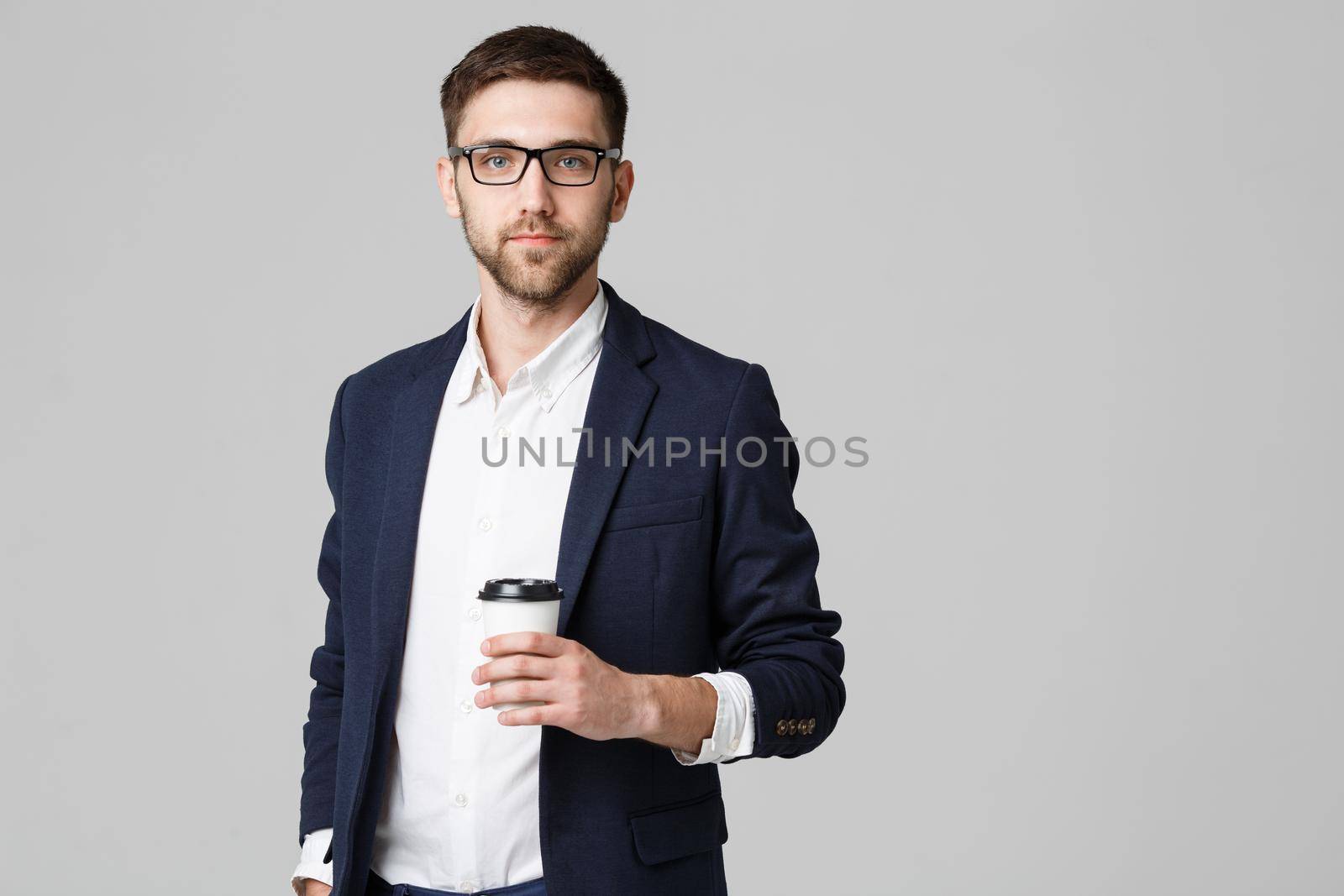 Portrait of a handsome businessman in eyeglasses with a cup of coffee. by Benzoix