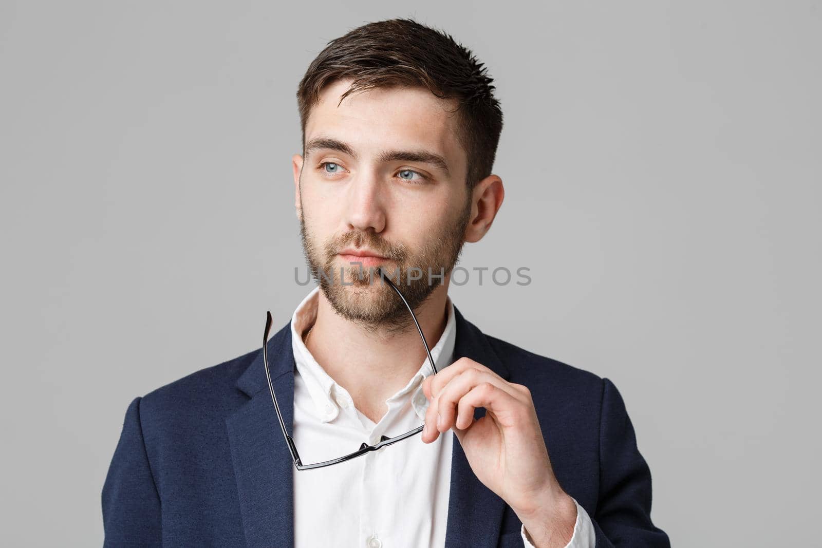 Business Concept - Portrait of a handsome businessman in suit with glasses serious thinking with stressful facial expression. Isolated White background. Copy Space.