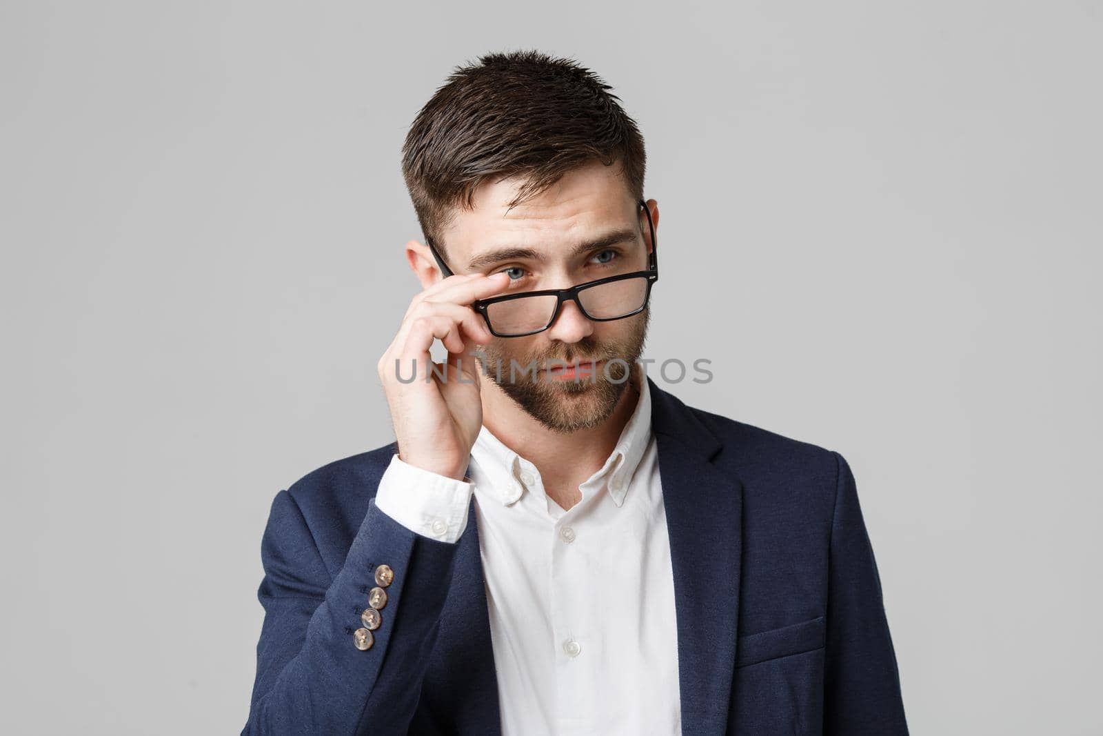 Business Concept - Portrait of a handsome businessman in suit with glasses serious thinking with stressful facial expression. Isolated White background. Copy Space. by Benzoix