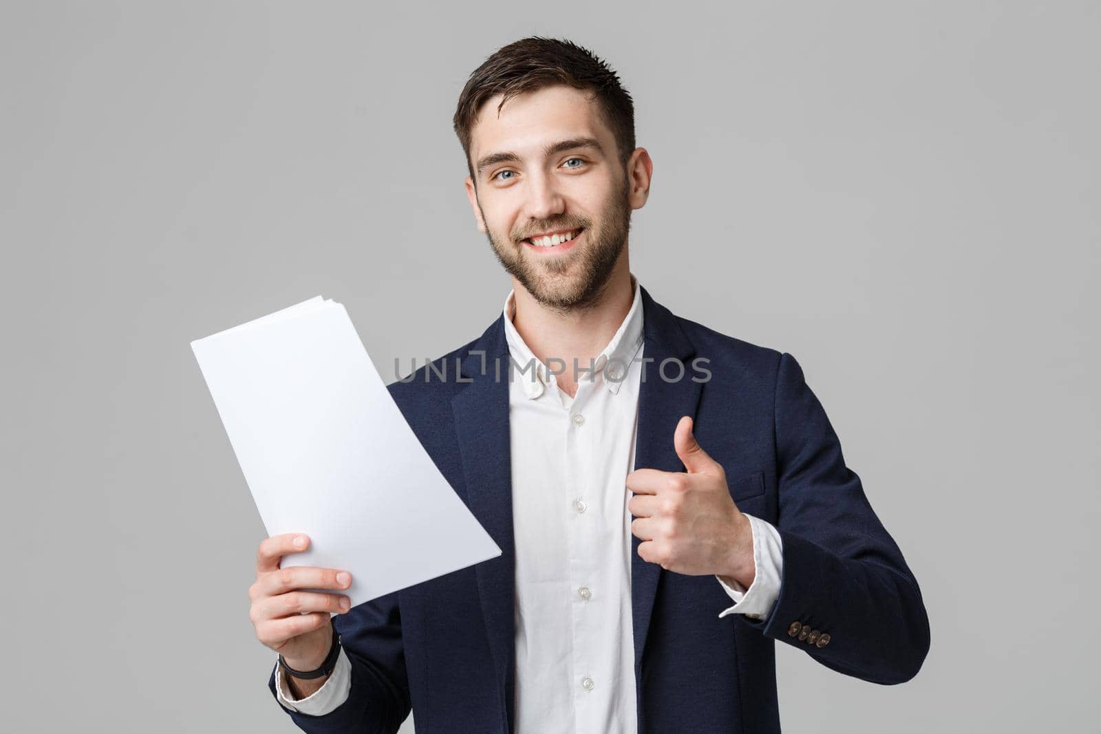 Business Concept - Portrait Handsome Business man holding white report with confident smiling face and thump up. White Background. by Benzoix