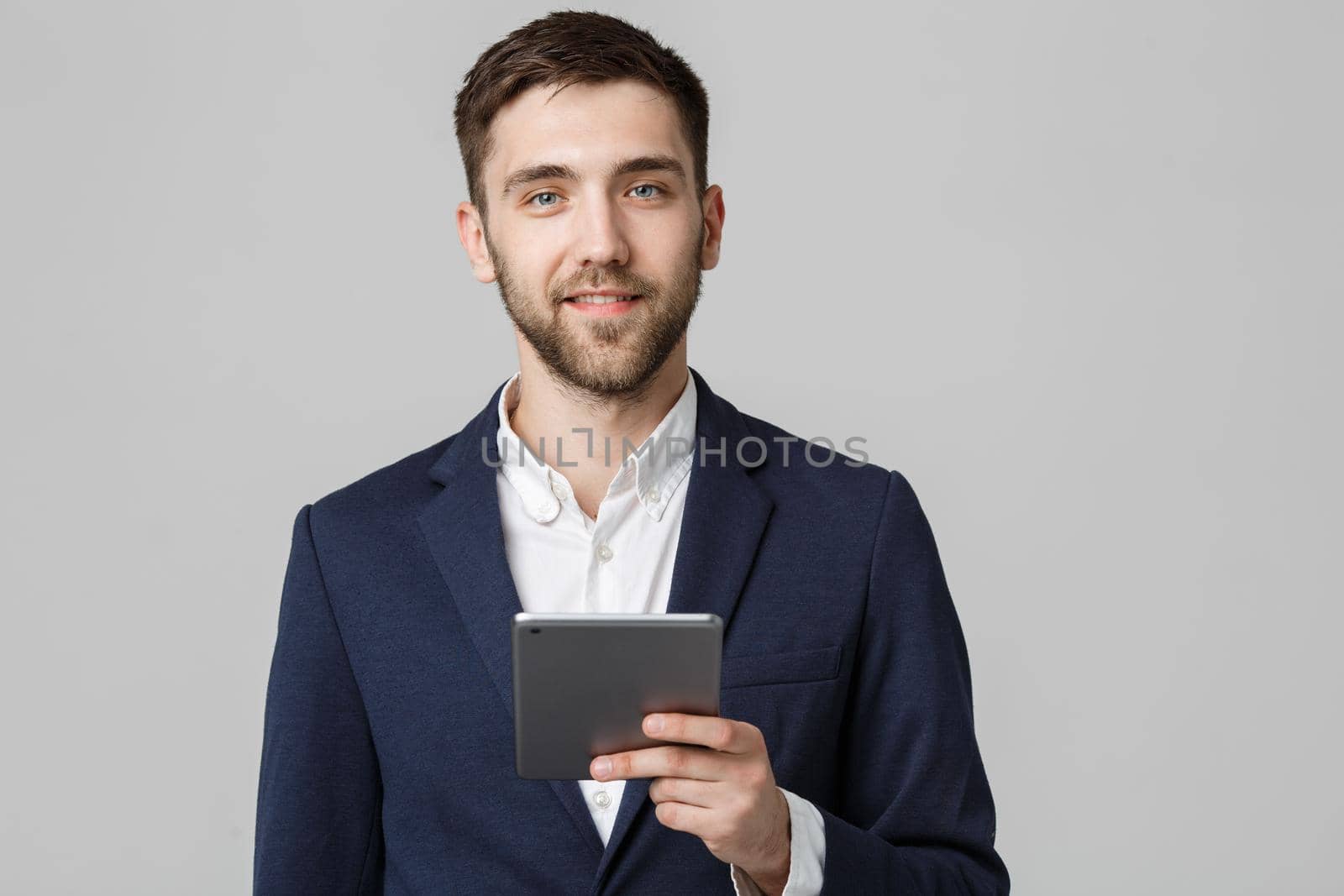 Business Concept - Portrait Handsome Business man playing digital tablet with smiling confident face. White Background. Copy Space.