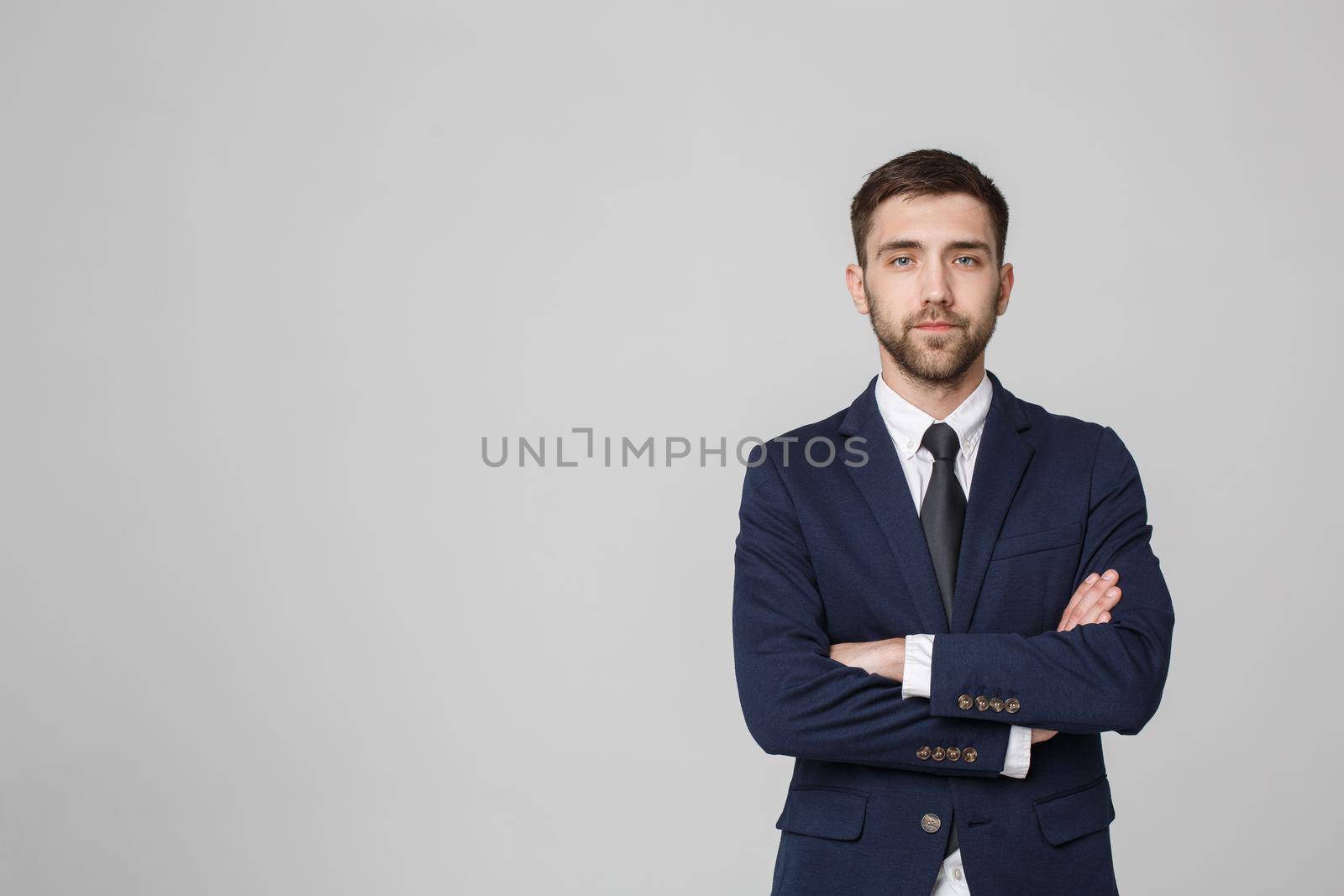 Young successful businessman posing over dark background. Isolated White Background. Copy space.