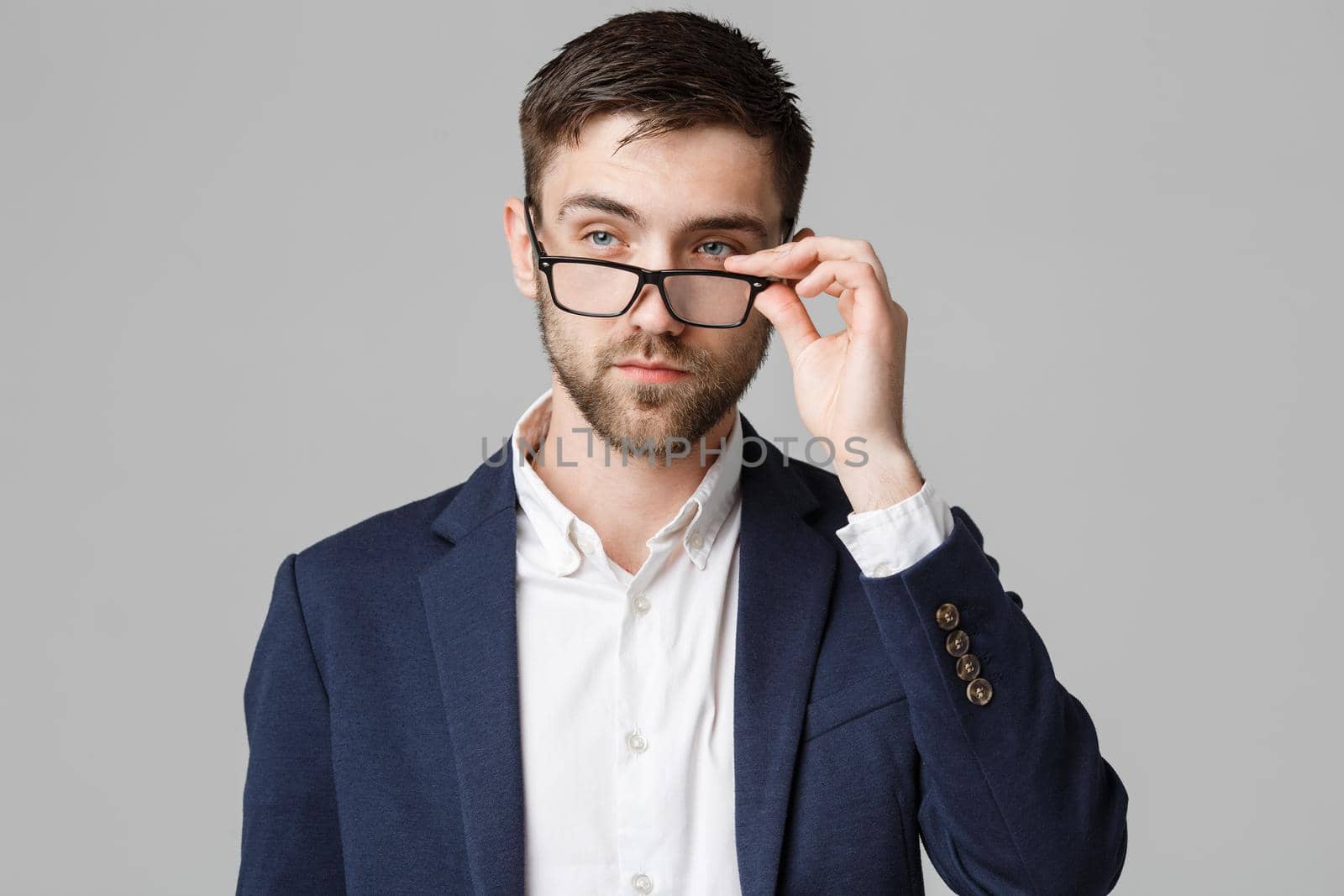 Business Concept - Portrait of a handsome businessman in suit with glasses serious thinking with stressful facial expression. Isolated White background. Copy Space. by Benzoix