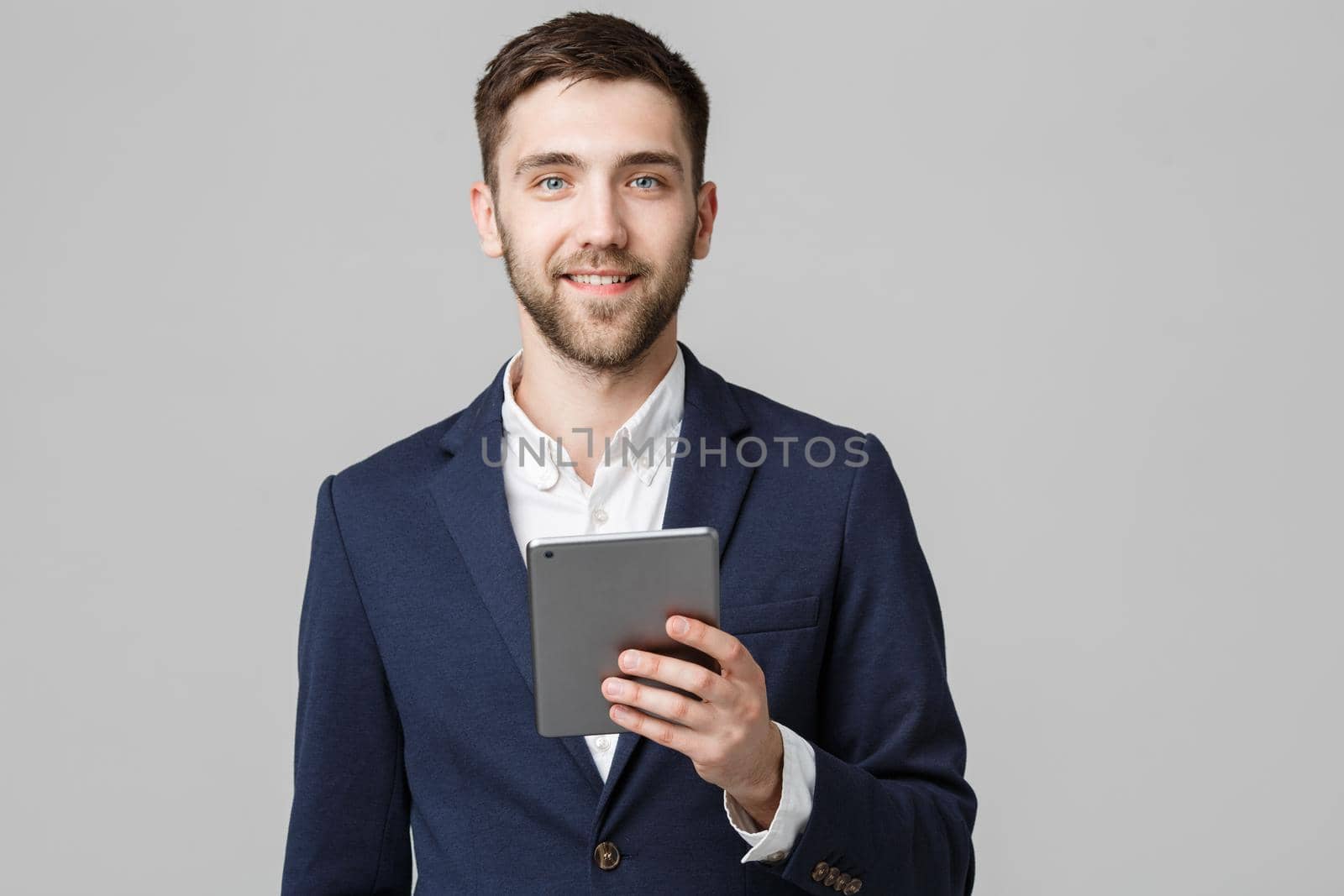 Business Concept - Portrait Handsome Business man playing digital tablet with smiling confident face. White Background. Copy Space.