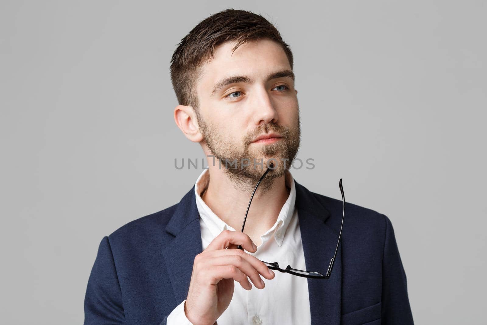 Business Concept - Portrait of a handsome businessman in suit with glasses serious thinking with stressful facial expression. Isolated White background. Copy Space. by Benzoix