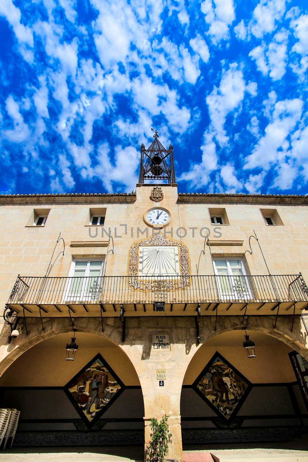 Novelda, Alicante, Spain- September 18, 2021: Beautiful Novelda Town Hall facade under Altocumulus Floccus clouds in summer