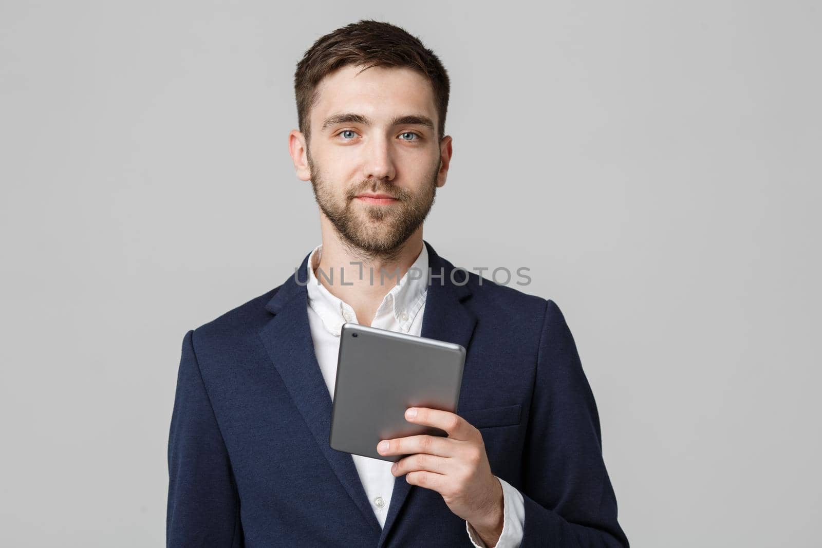 Business Concept - Portrait Handsome Business man playing digital tablet with smiling confident face. White Background. Copy Space.
