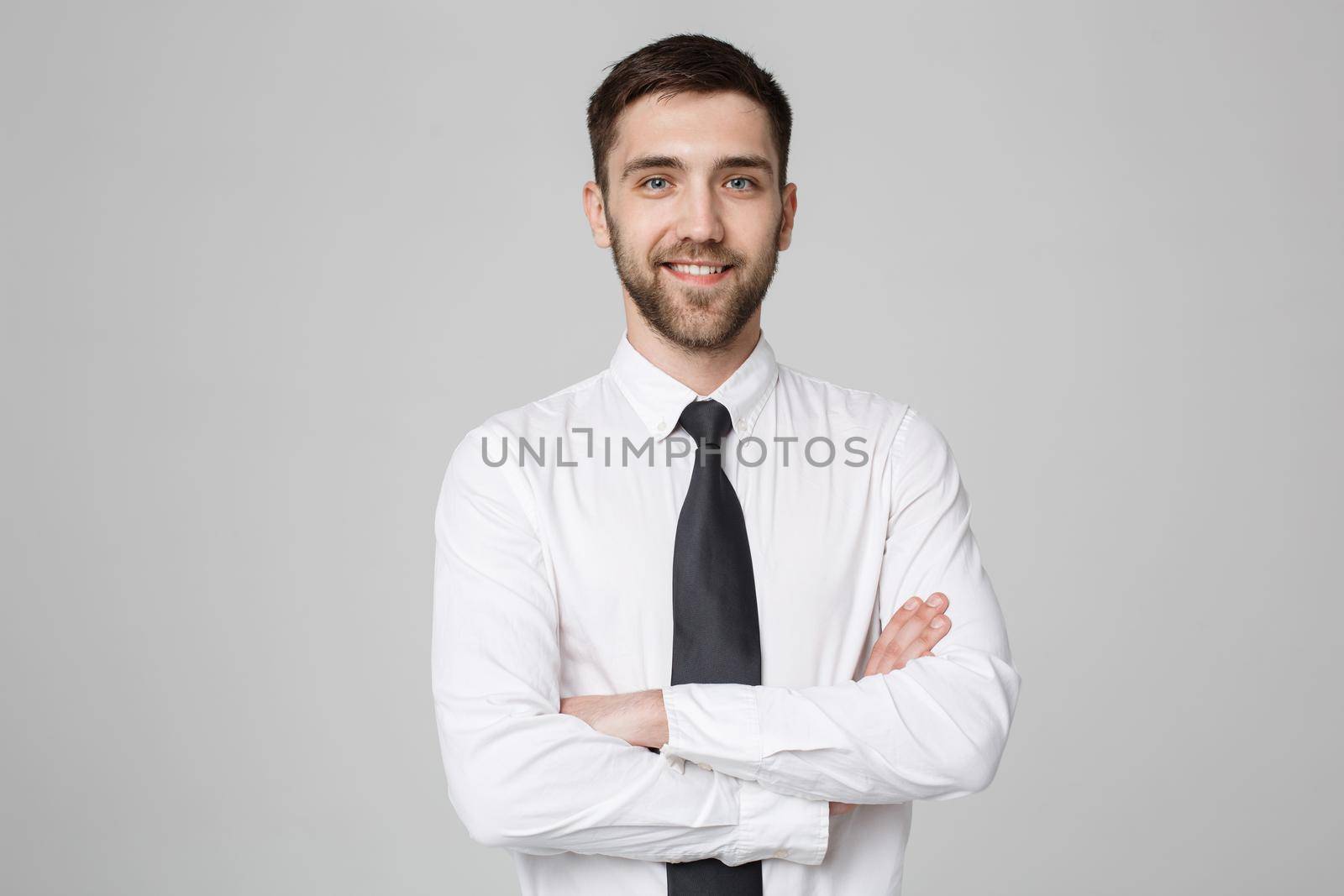 Business Concept - Young successful businessman posing over dark background. Copy space. by Benzoix