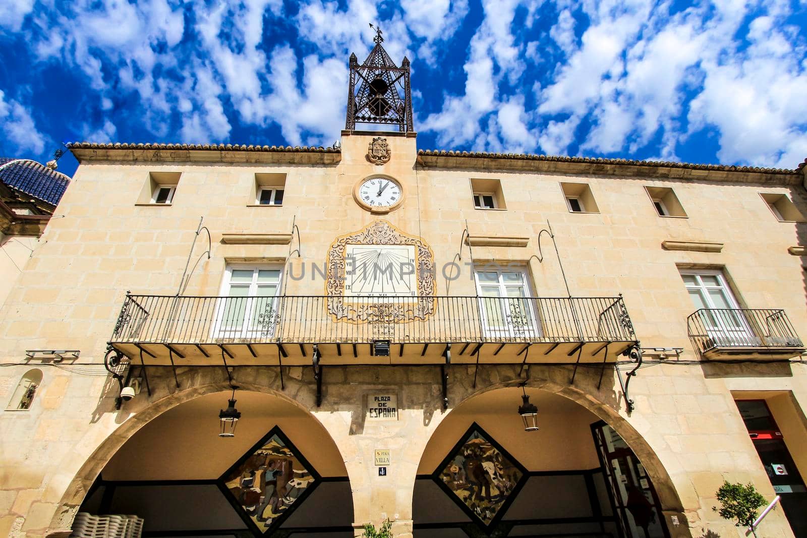 Novelda, Alicante, Spain- September 18, 2021: Beautiful Novelda Town Hall facade under Altocumulus Floccus clouds in summer