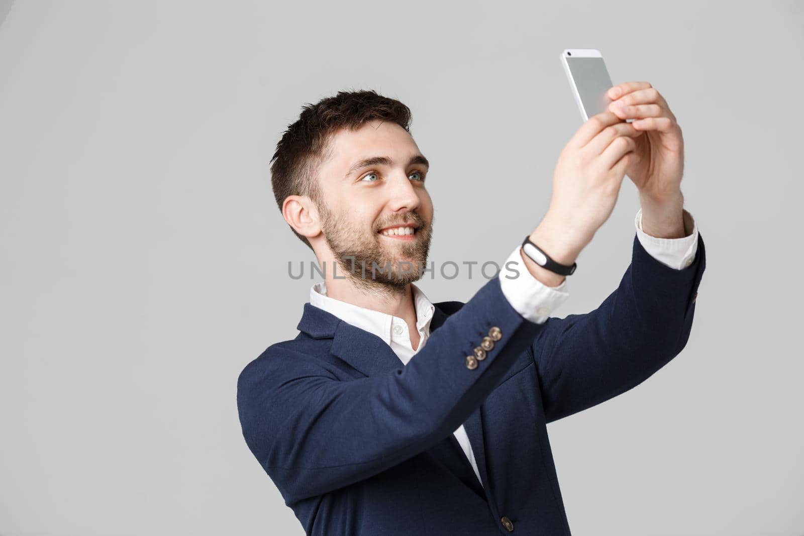 Business Concept - Portrait Handsome Business man take a selfie of himself with smartphone. White Background.