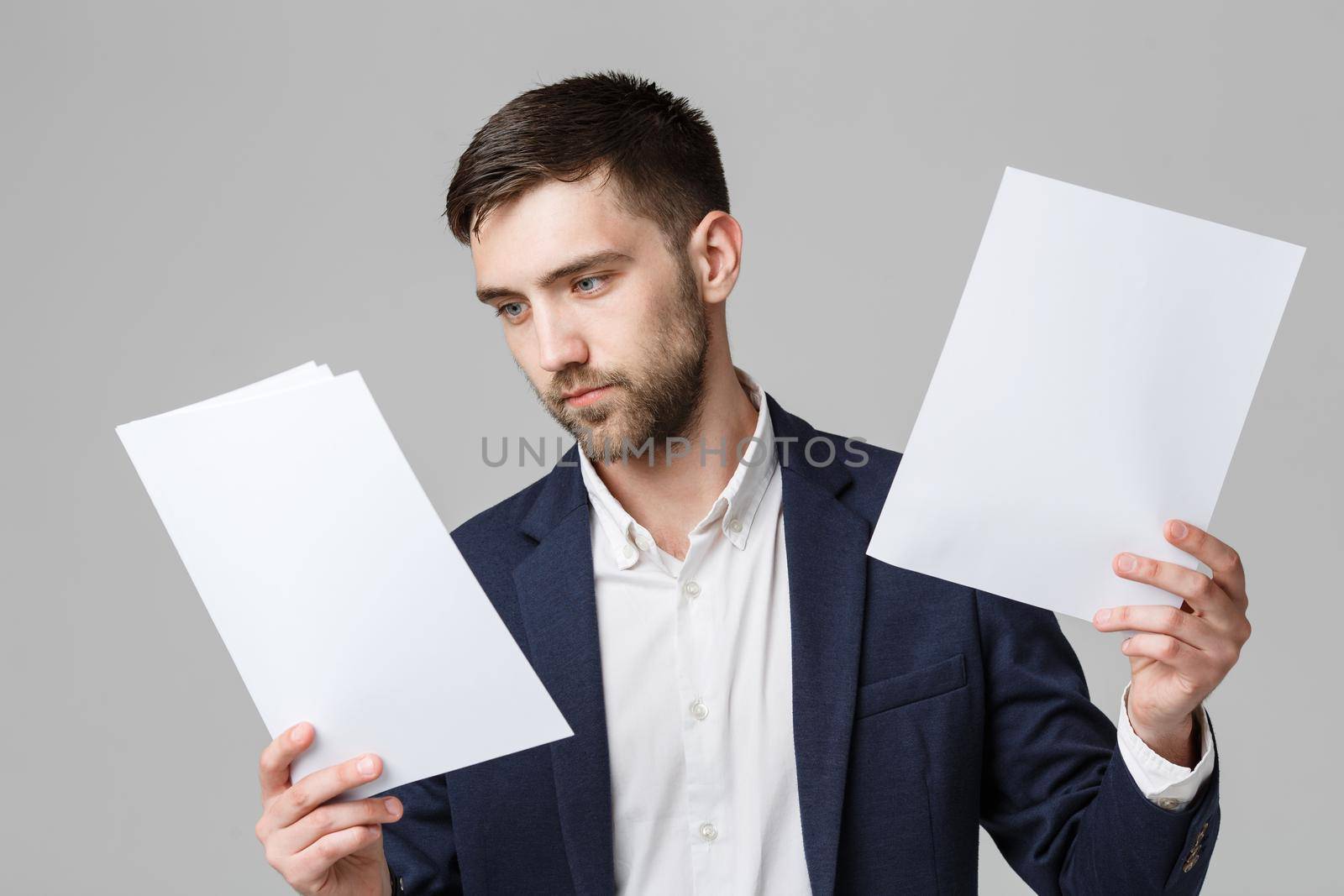 Business Concept - Handsome Business man serious working with annual report. White Background.