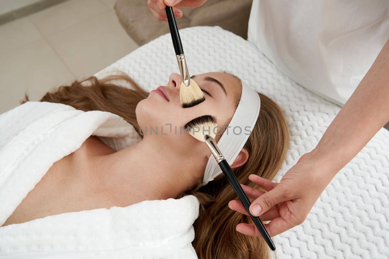 Face Skin Care. Woman Gets Brushes Treatment At Beauty Clinic
