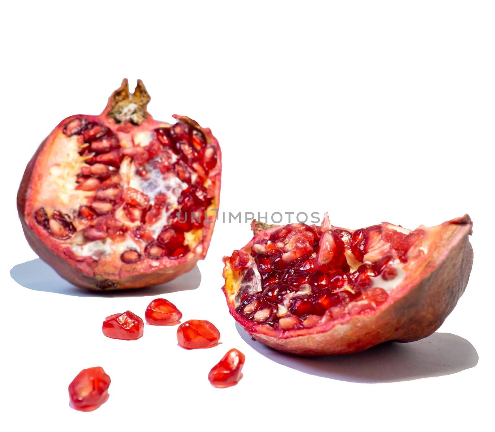 Pomegranate on white background. Useful product by Puludi