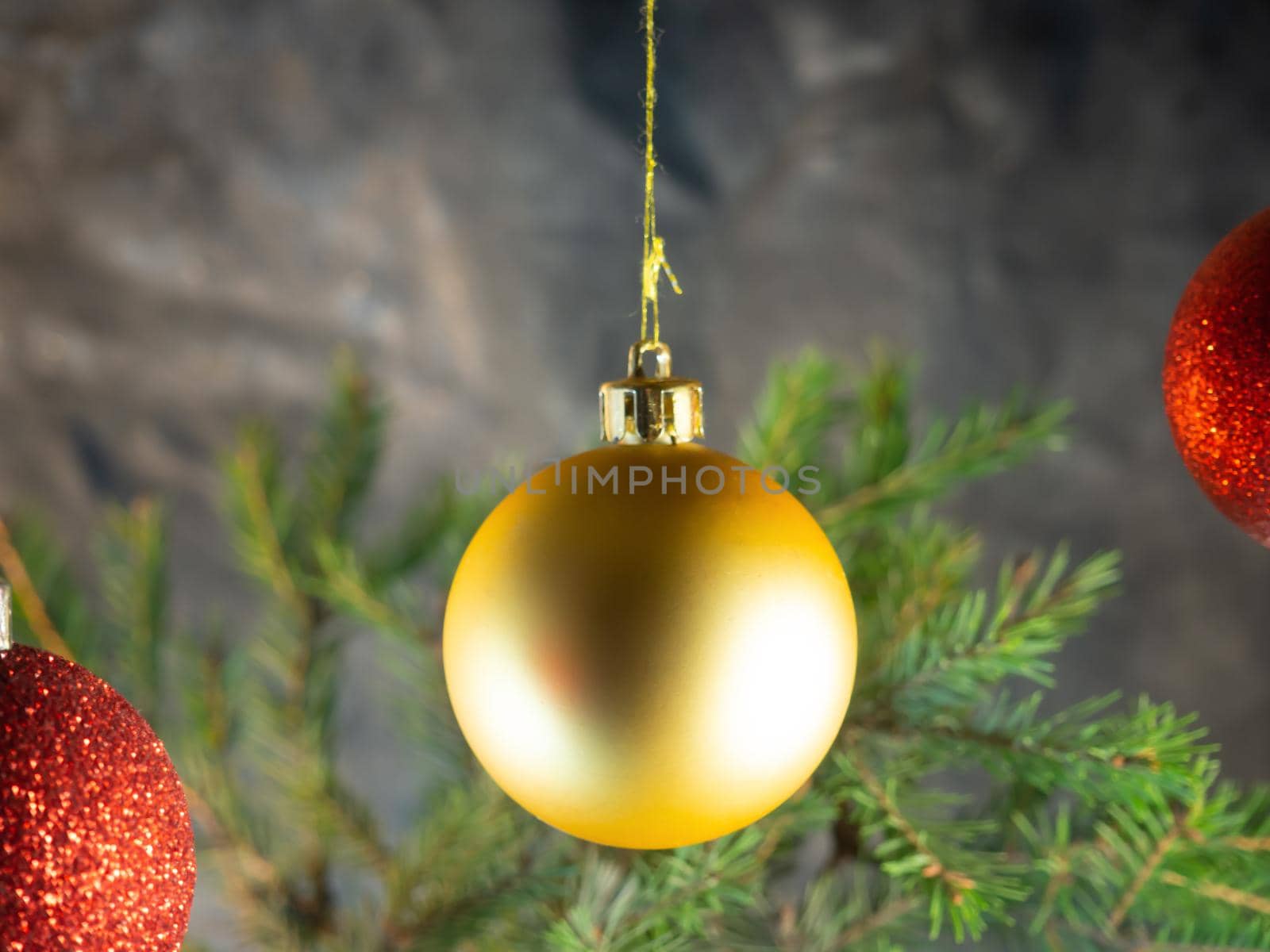 golden Christmas ball on the background of fir branches. Christmas decoration
