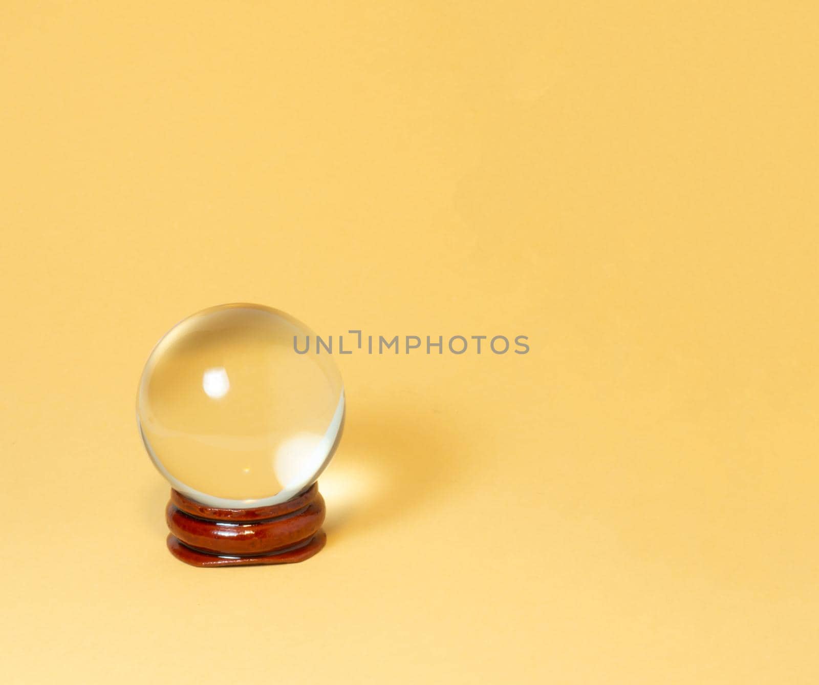 Crystal ball on a yellow background. by Puludi