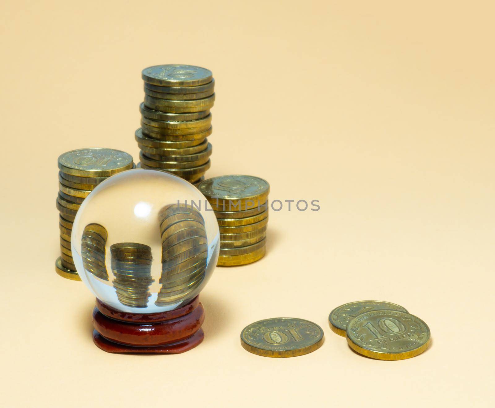 Pyramids of coins are reflected in a glass ball.
