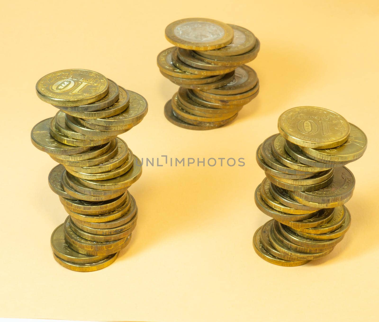 Coin turrets. Money on yellow background by Puludi