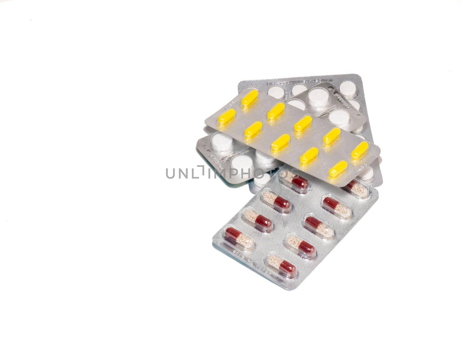 Pills on a white background. Various medicines in blisters. by Puludi