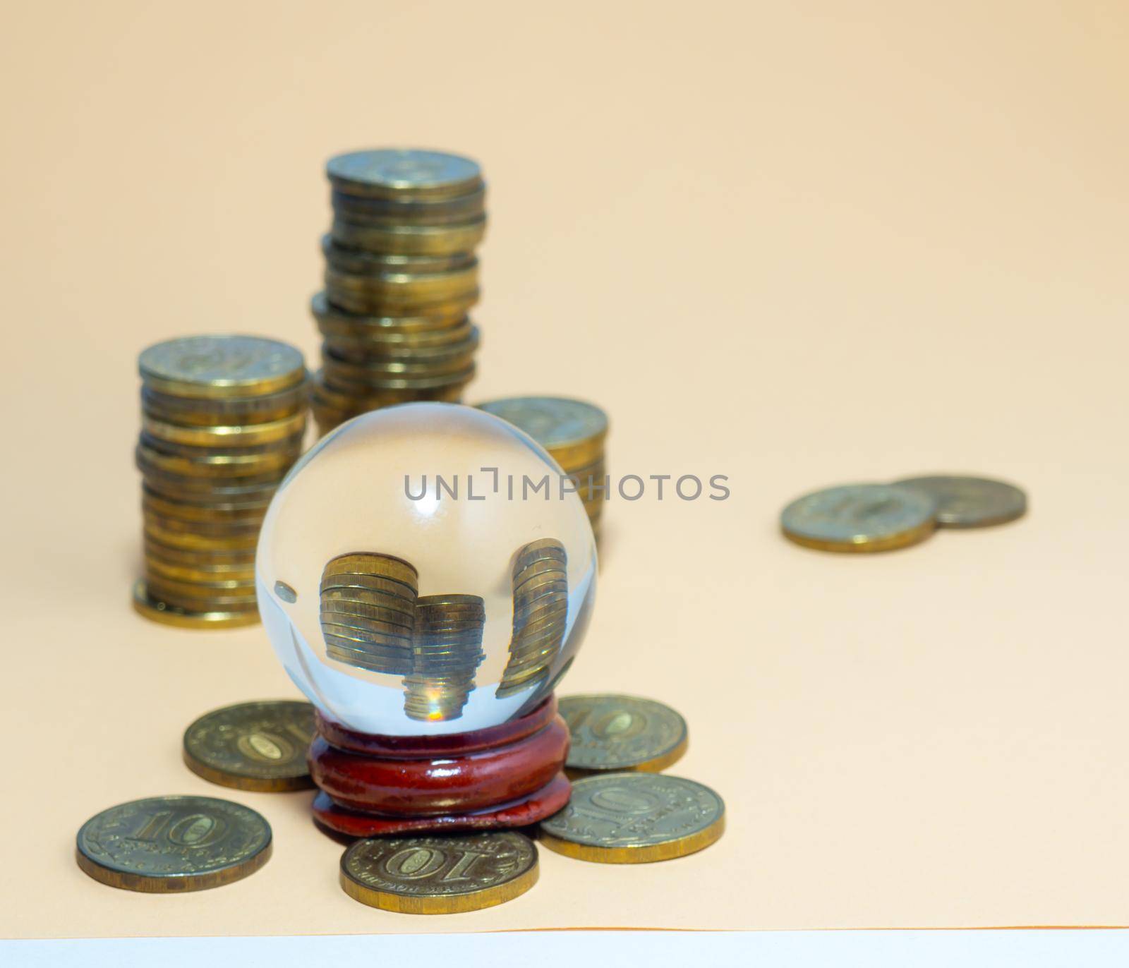 Pyramids of coins are reflected in a glass ball. by Puludi