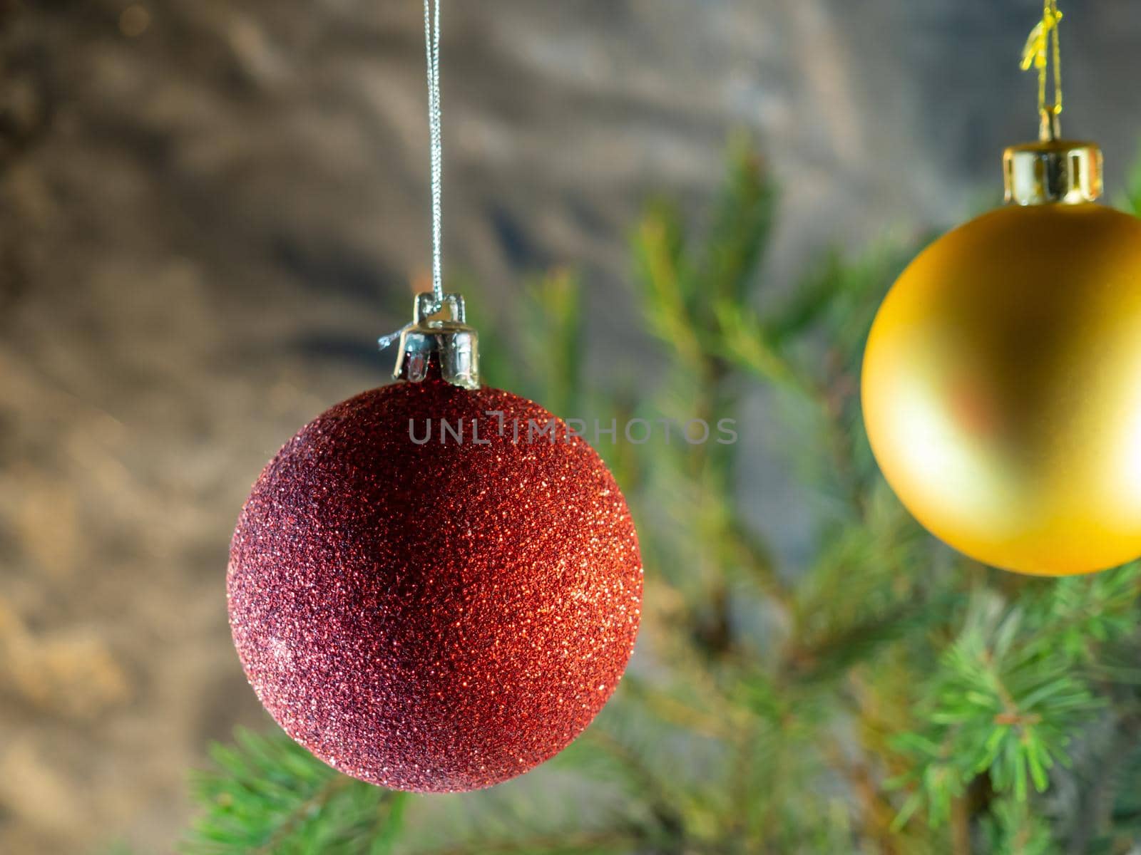 red Christmas ball on the background of fir branches. Christmas decoration by Puludi