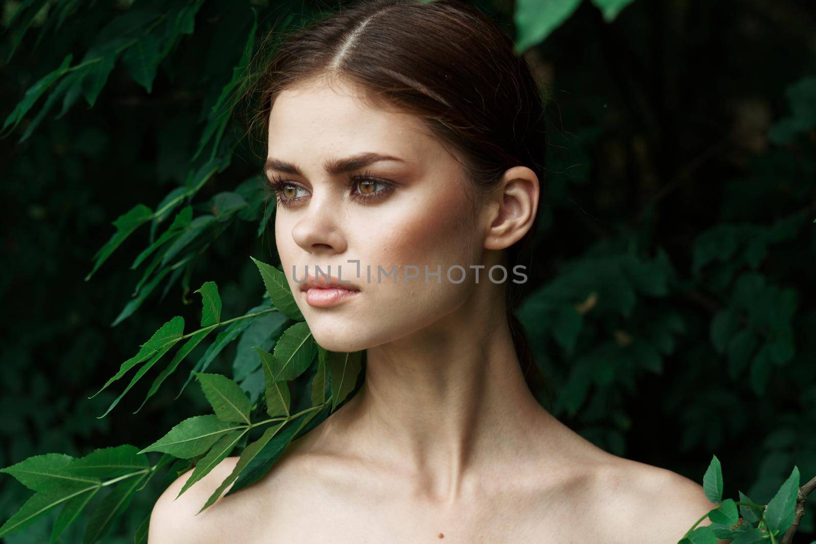 attractive woman skin care bare shoulders green leaves nature Lifestyle. High quality photo