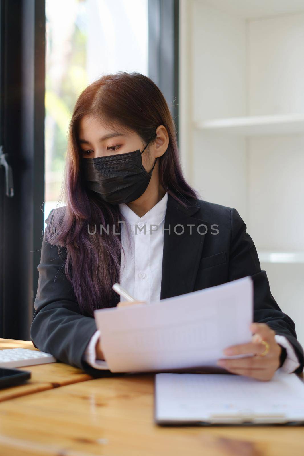 Business woman or broker wear mask and checking contract agreement paper with customer to sign contract. Real Estate and Agreement concept