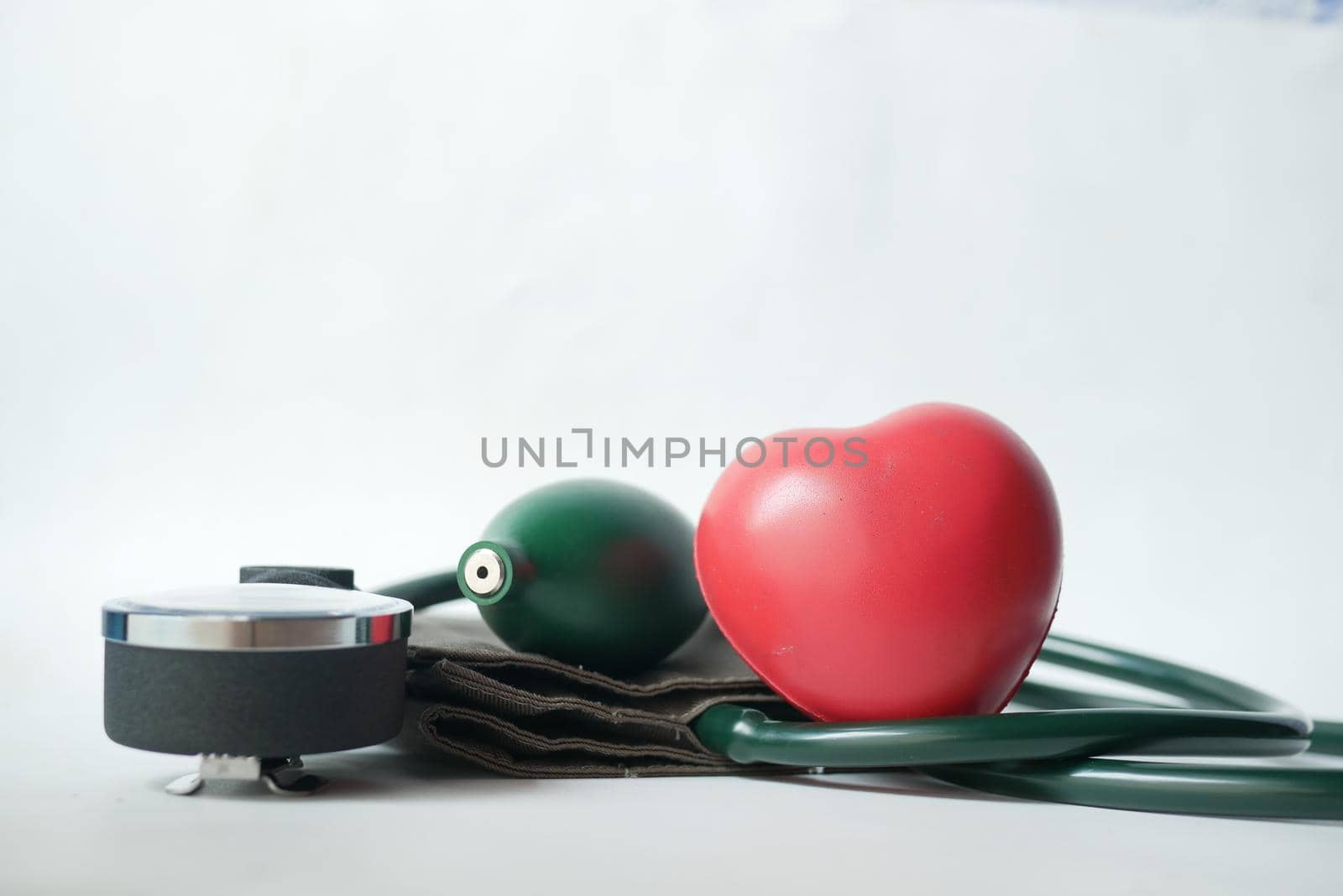 blood pressure machine and heart shape on white background by towfiq007