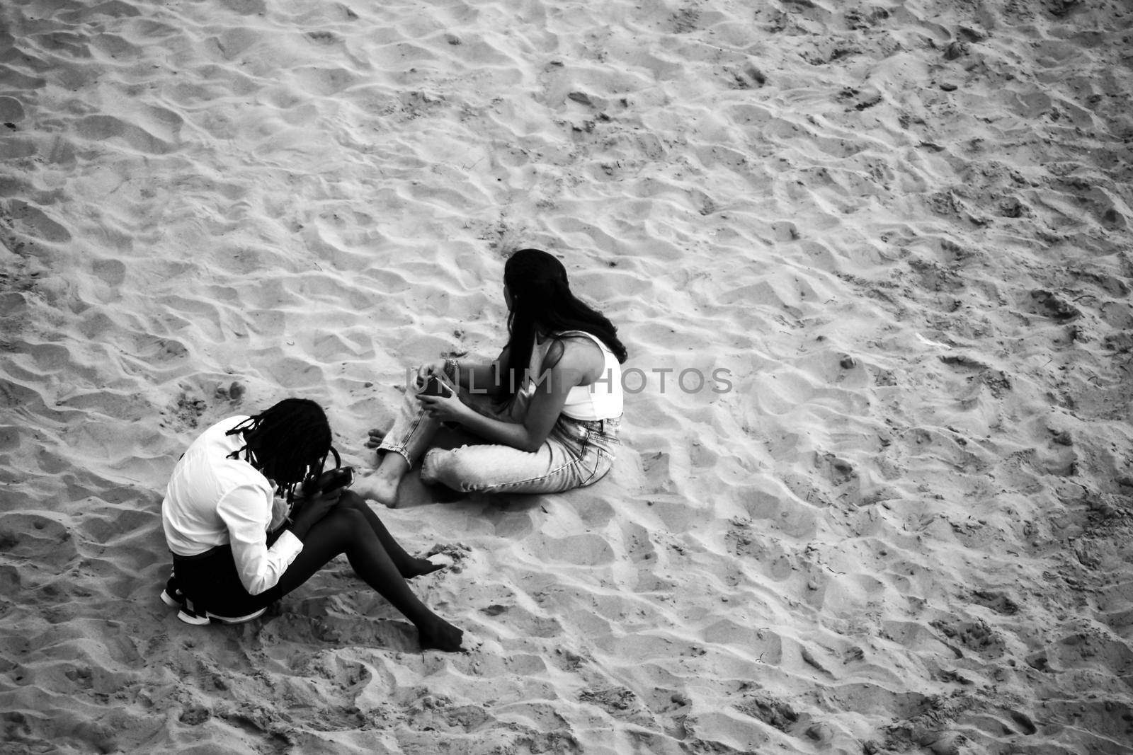 People sunbathing by the shore on the beach on a Sunny day of Autumn in Benidorm