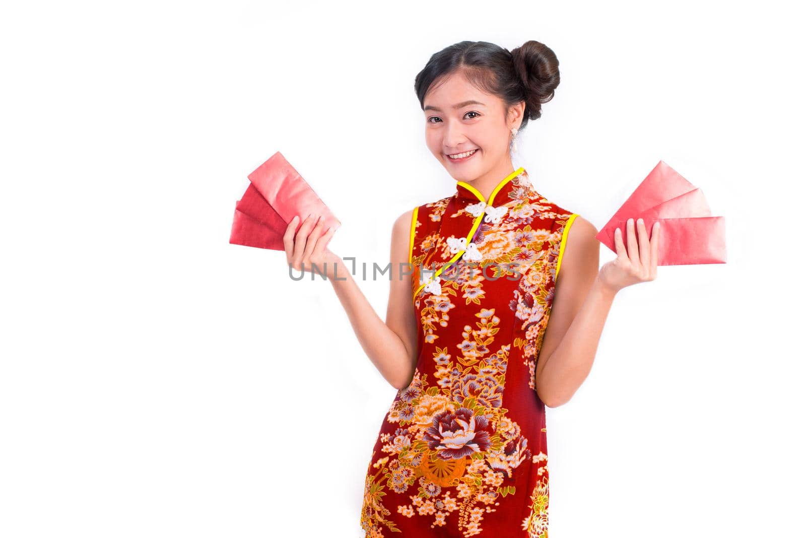 Young Asian beauty woman wearing cheongsam and carry red packet of money in Chinese new year festival event on isolated white background. Holiday and Lifestyle concept. Qipao dress wearing