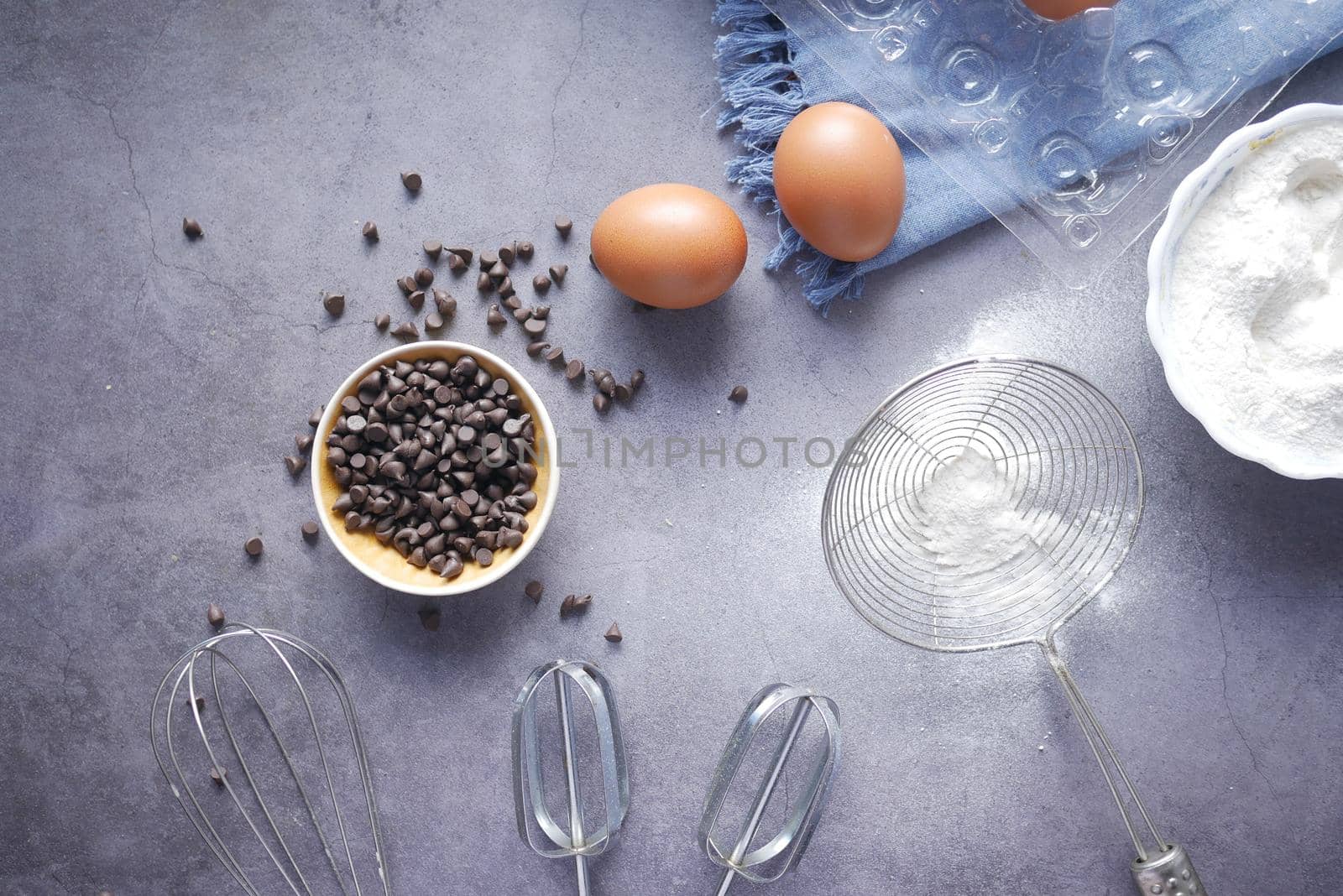 chicken eggs and baking ingredients on a wooden board,