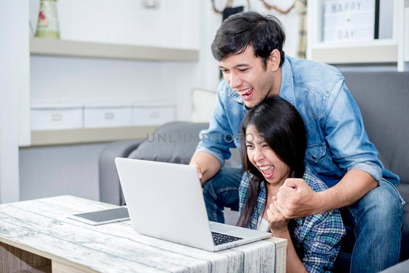 Lover are surprising when using the laptop. Family concept, Lovers concept, Technology concept by MiniStocker