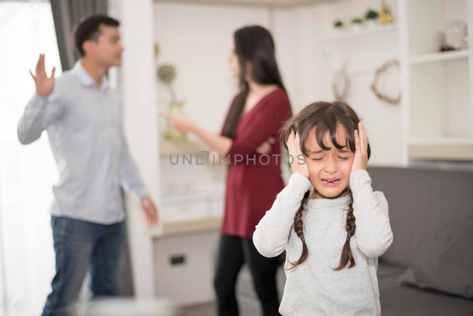 Little girl was crying because dad and mom quarrel, Sad and dramatic scene, Family issued, Children's Rights abused in Early Childhood Education and Social and parrents care problem concept
