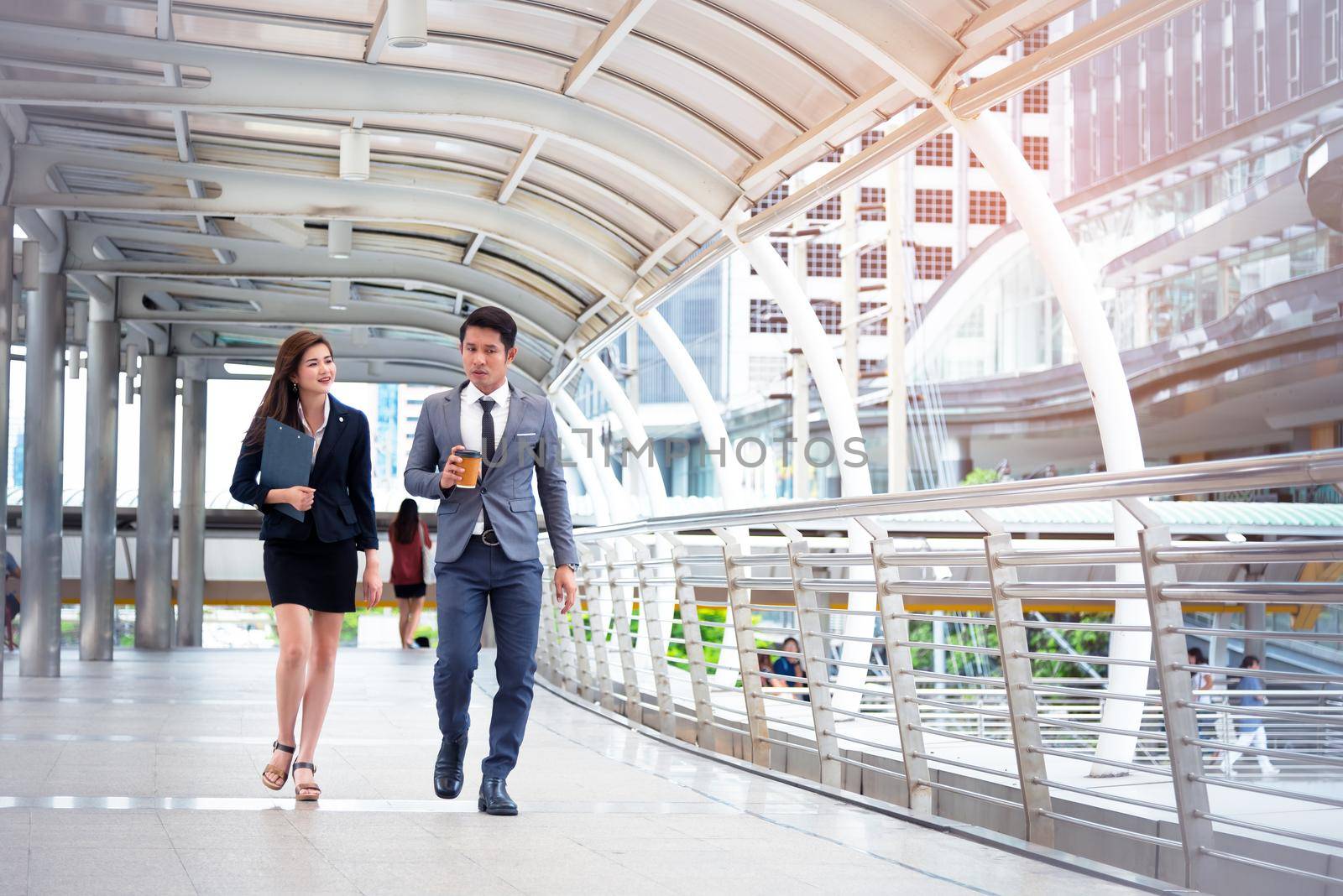 Businessman and his secretary walking and talking together, Business concept, Relationship concept, Teamwork concept