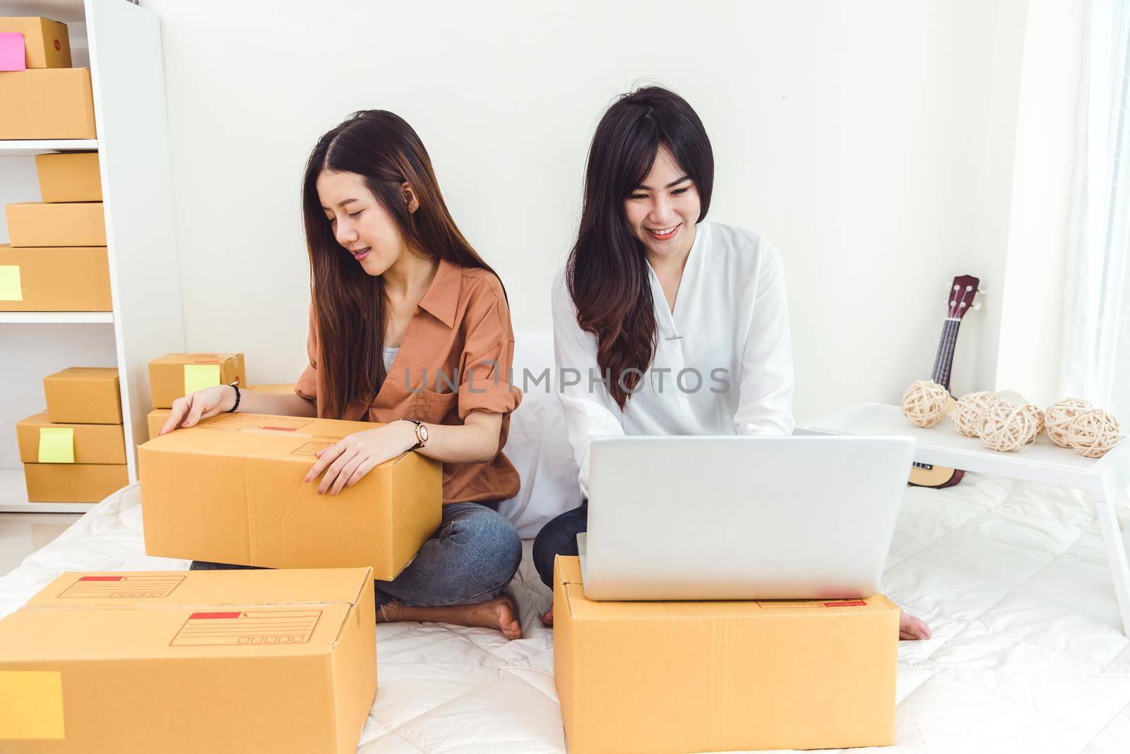 Young Asian woman startup small business entrepreneur SME distribution warehouse with parcel mail box. Owner home office concept. Online marketing and product packaging and delivery service.