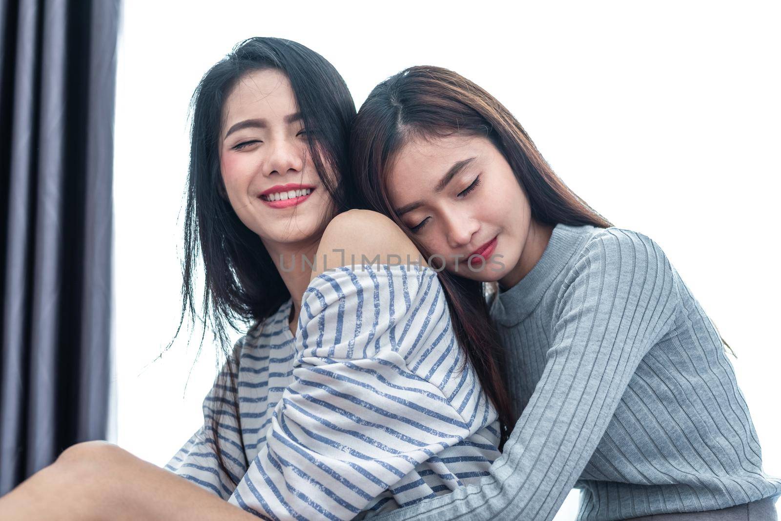 Two Asian Lesbian women hug and embracing together in bedroom. Couple people and Beauty concept. Happy lifestyles and home sweet home theme. Homosexual life theme. Love scene making of female