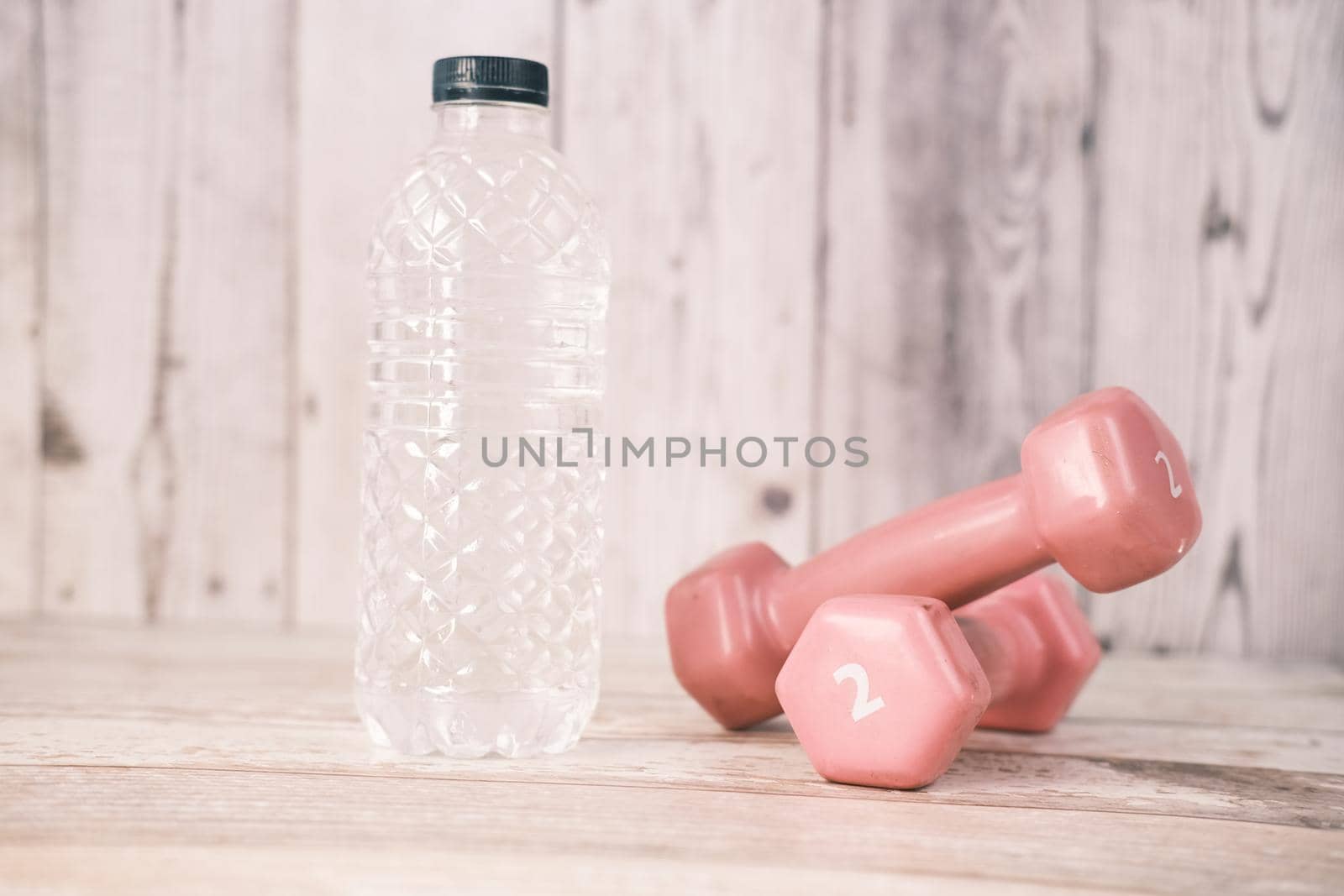 fresh drinking water and a pink color dumbbell on table by towfiq007