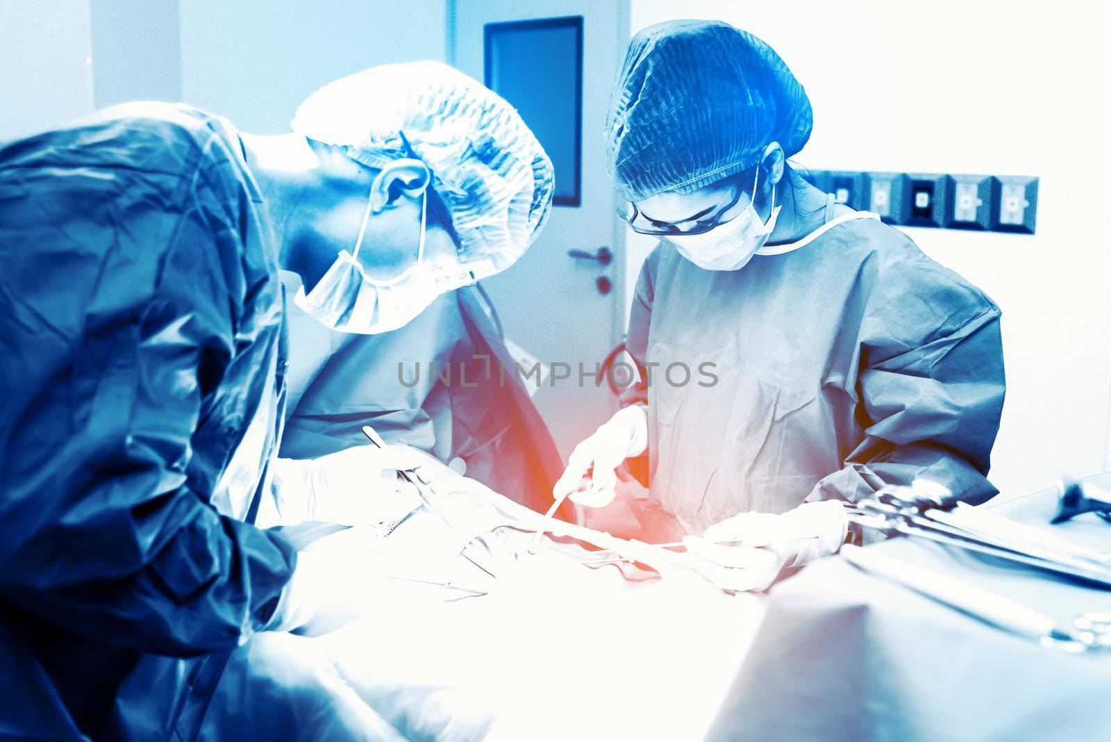 Doctor and assistant nurse operating for rescue patient from dangerous emergency case. Hospital and Surgery Concept. Health care and Medical concept. Cancer and disease treatment. Blue tone filter  by MiniStocker