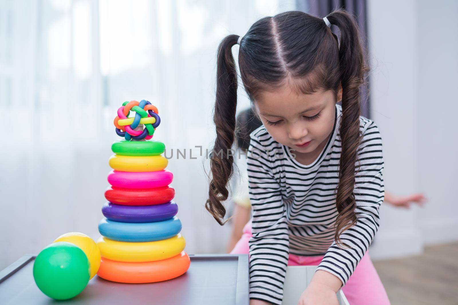 Little girls playing small toy hoops in home. Education and Happiness lifestyle concept. Funny learning and Children development theme. Smile faces