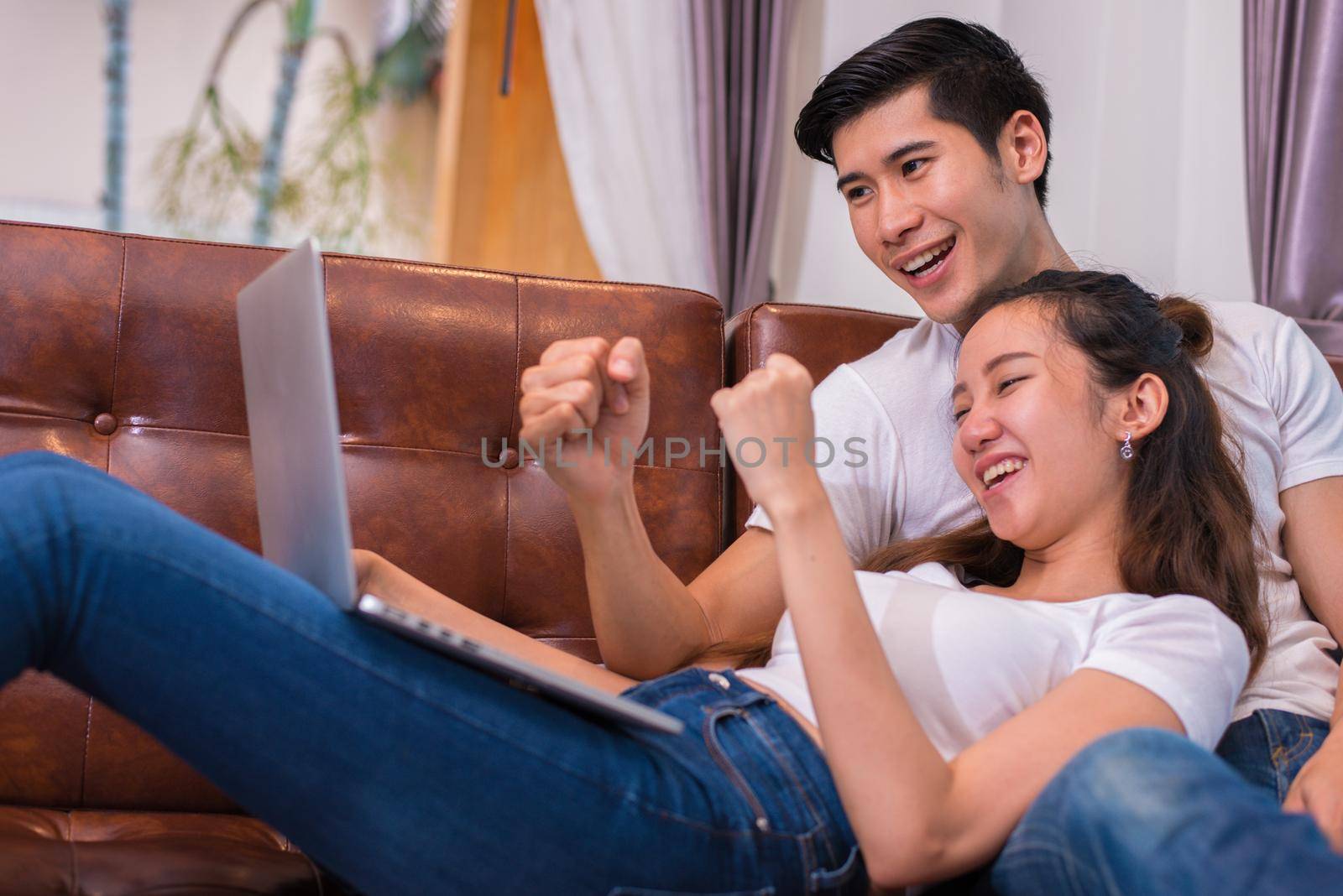 Asian young couples using laptop. Lovers and Couples concept. Honeymoon and Wedding theme. Interior and Dating theme.