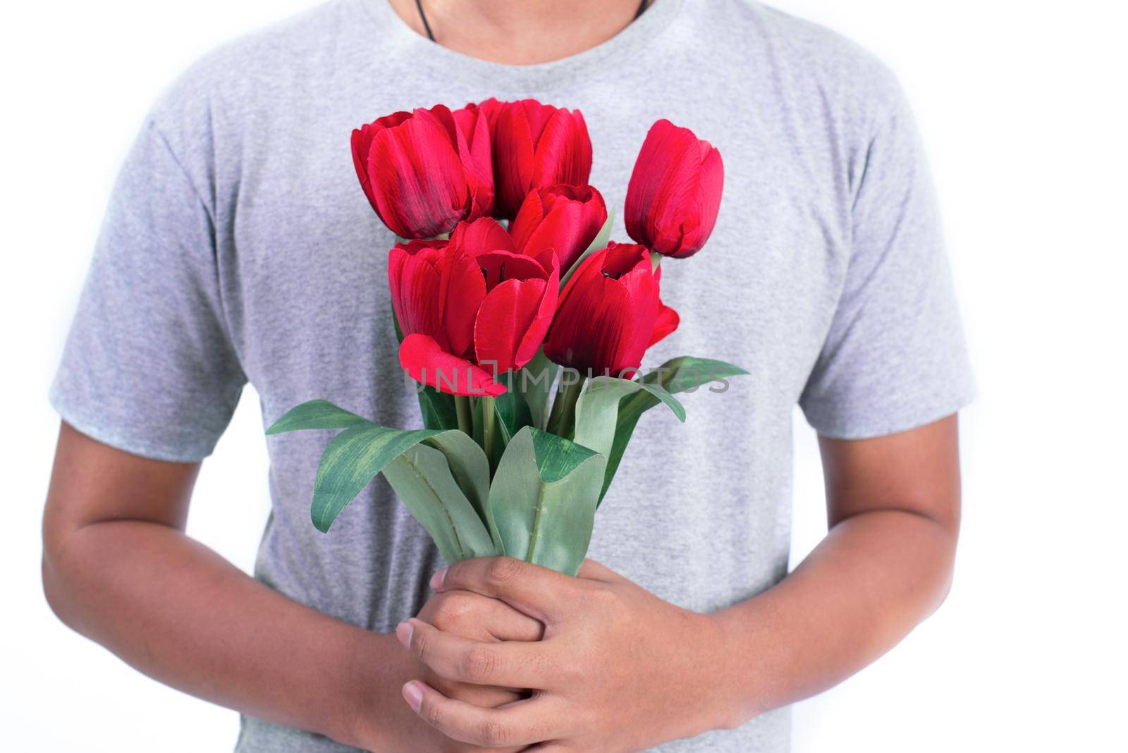 Man holding red rose flower. Valentines day and  Couples concept. Love and Flirting theme. Close up at rose. Body part and headless theme
