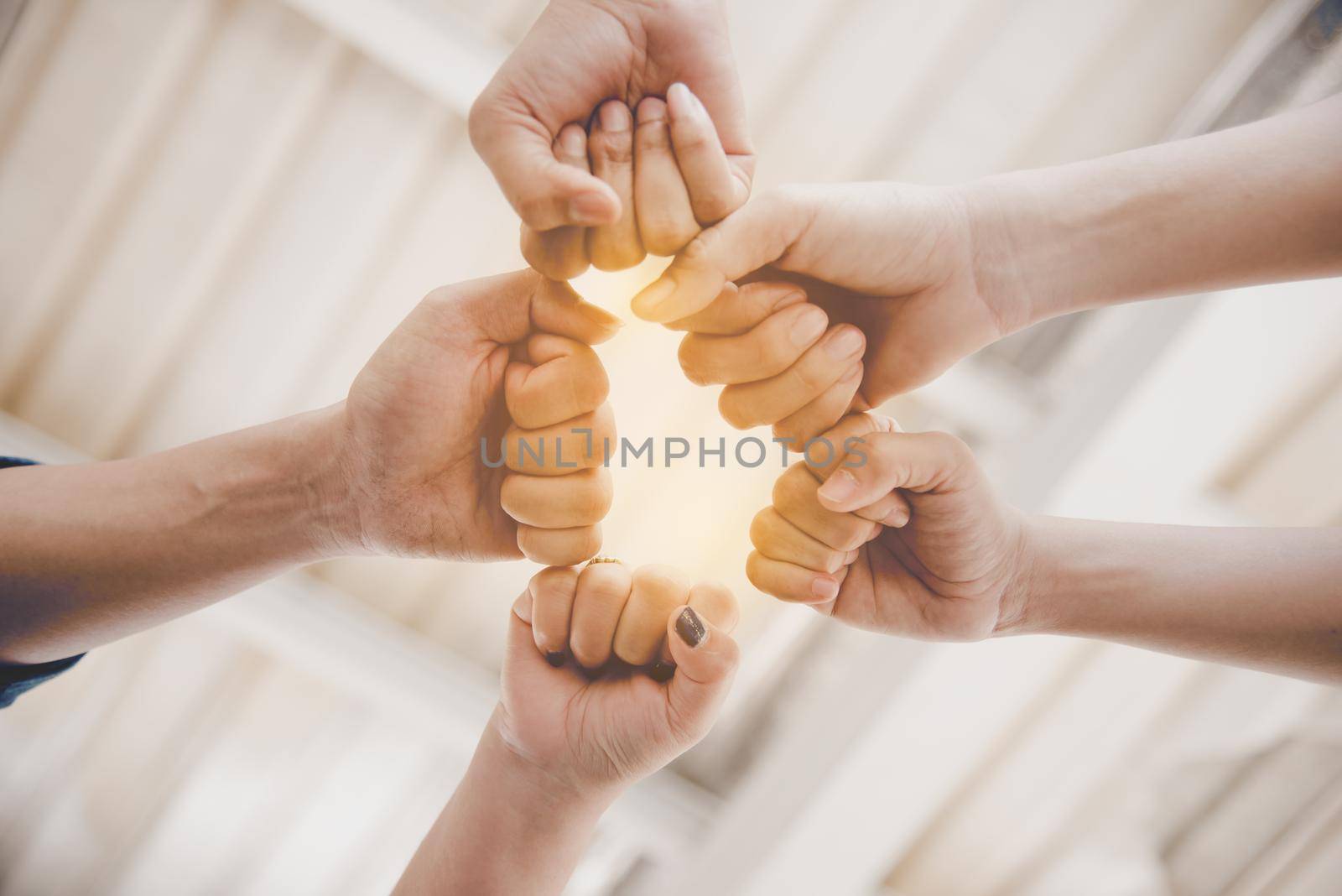 Fist Bump of friendship and teamwork for startup new project. Business and togetherness concept. Cooperation and Successful concept. People and hands theme. Warm tone filter
