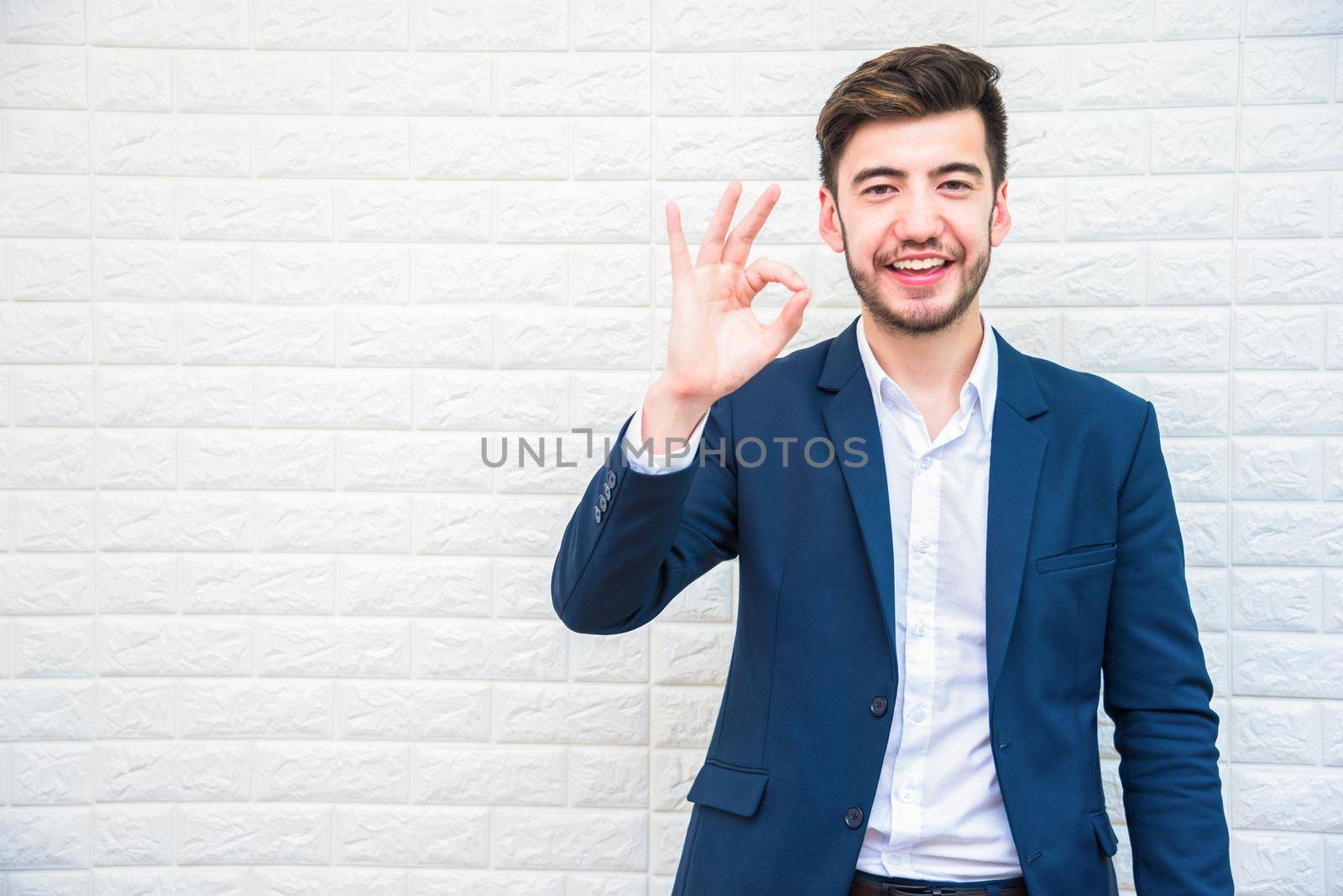 Handsome Businessman doing okay or alright gesture. Business and success concept. People and Portrait theme.