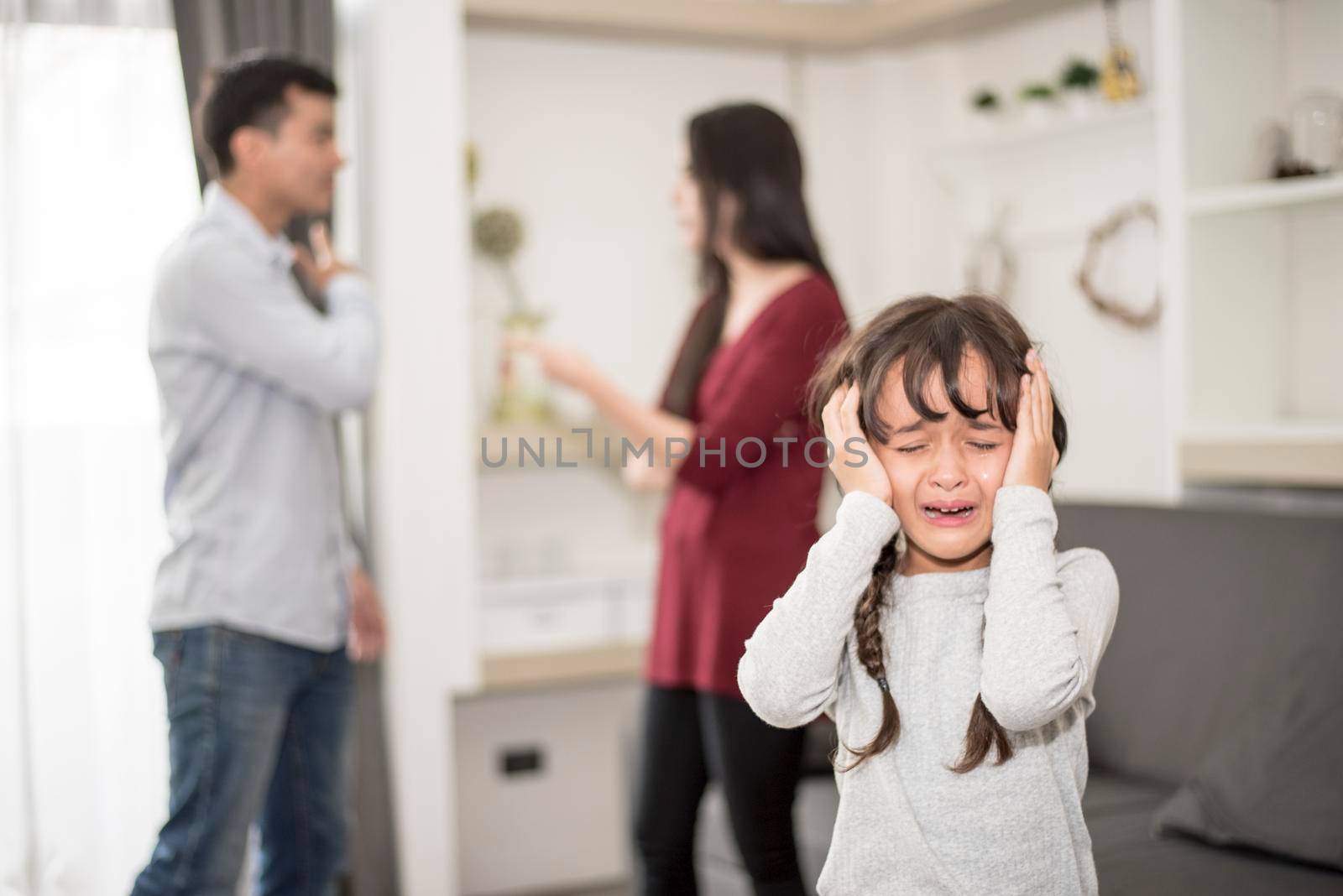 Little girl was crying because dad and mom quarrel, Sad and dramatic scene, Family issued, Children's Rights abused in Early Childhood Education and Social and parents care problem concept by MiniStocker