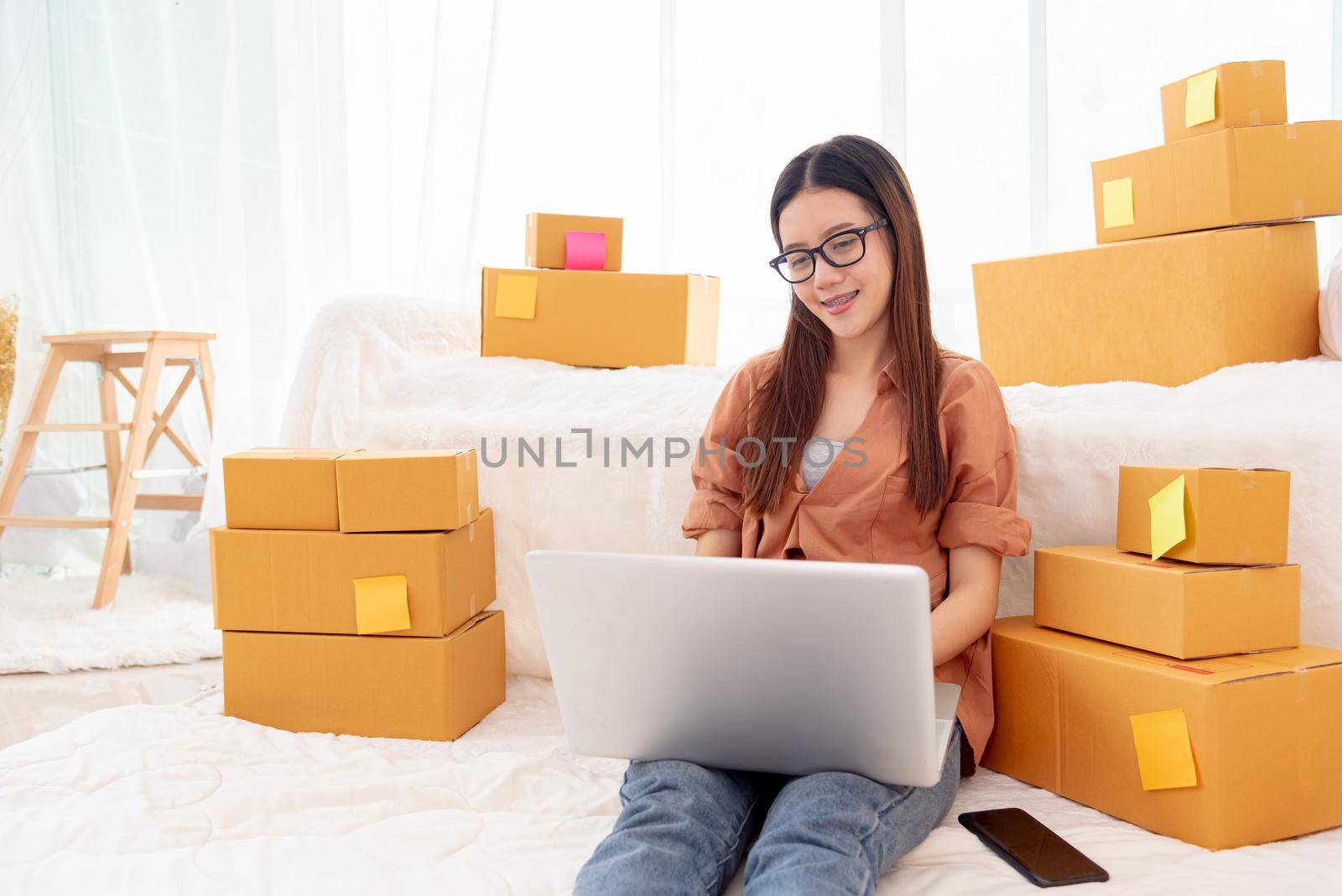 Beauty Asian woman using laptop for customer support in bedroom. Business and Technology concept. Delivery and Online shopping concept. Service theme. People lifestyle remote work in domestic house