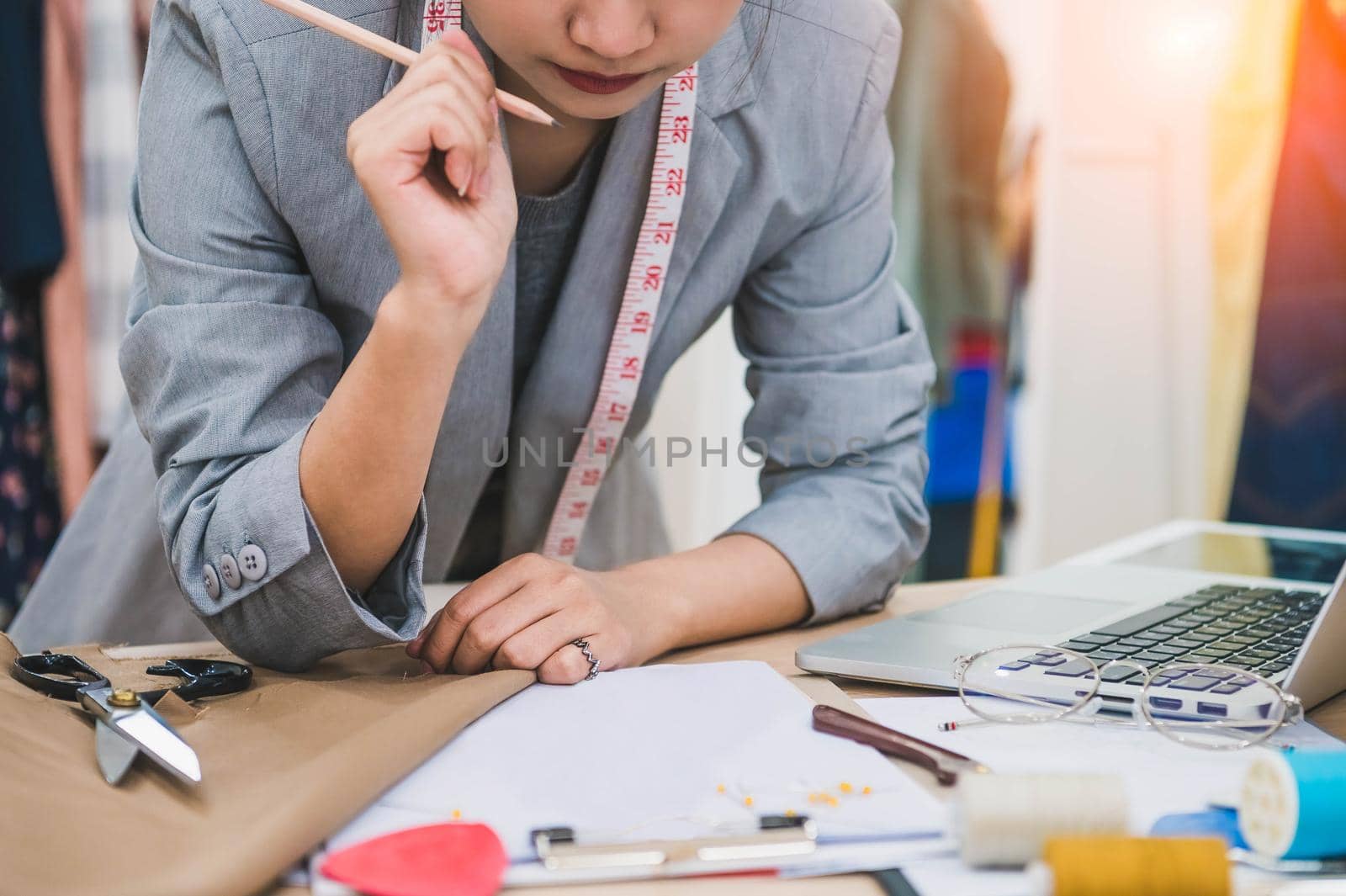 Attractive female fashion designer work hard in home office workshop. Stylish fashionista woman creating new cloth design collection. Tailoring and sewing. People lifestyle and occupation concept